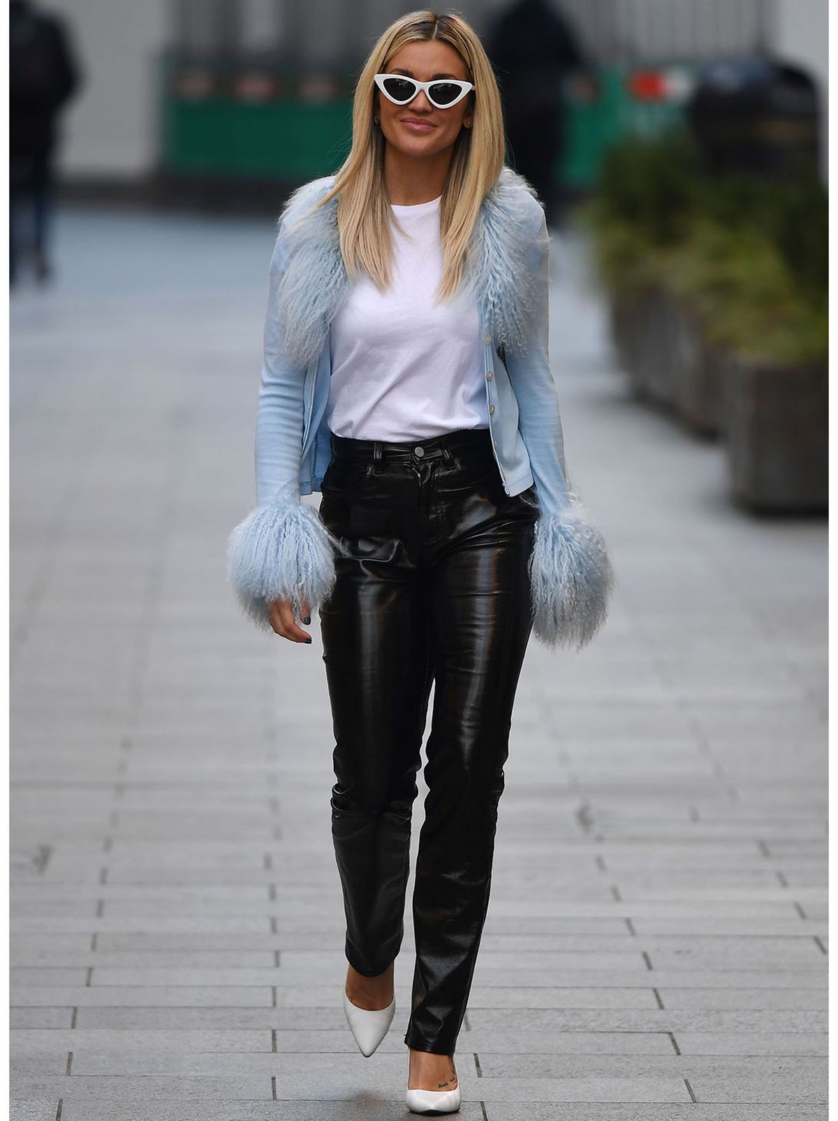 Ashley Roberts wearing a blue fir trim cardigan