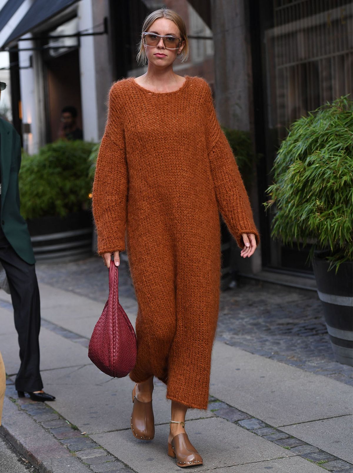 Woman wearing a orange knitted jumper dress