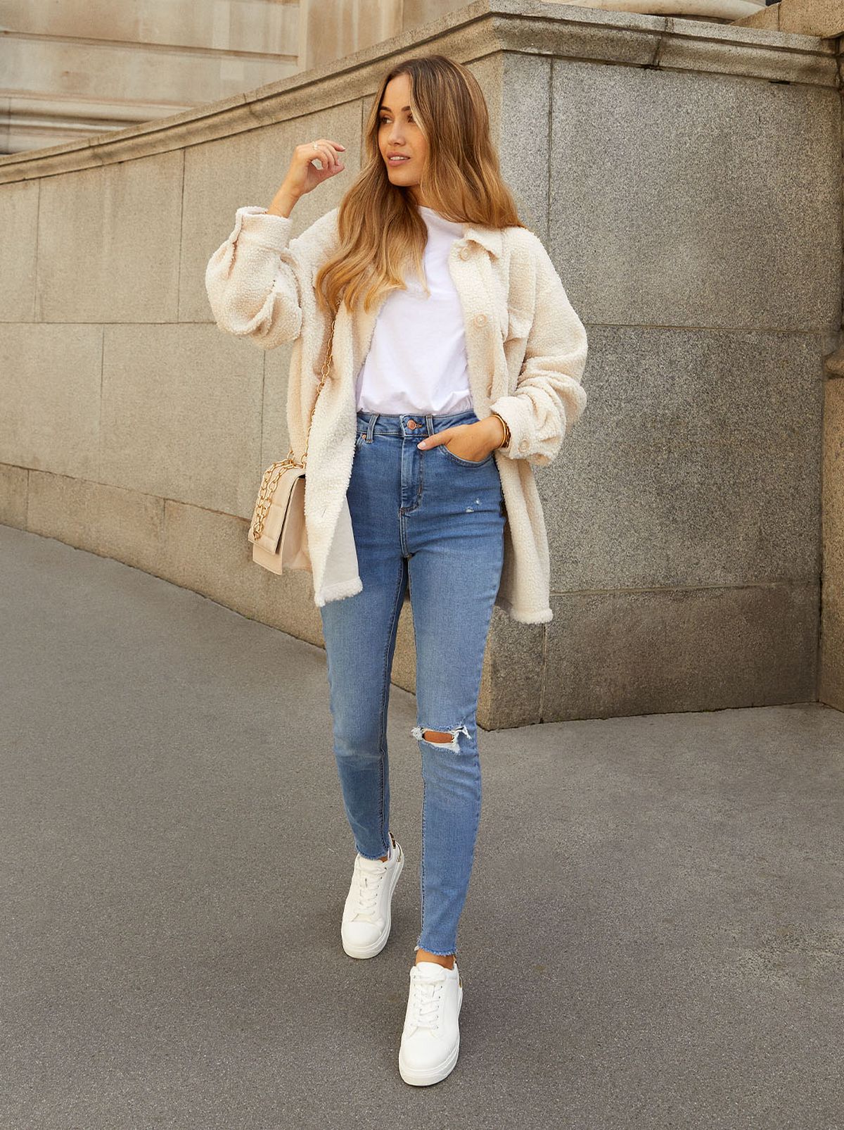 Kate Hutchins wearing blue skinny jeans and trainers with a cream cardigan and t-shirt