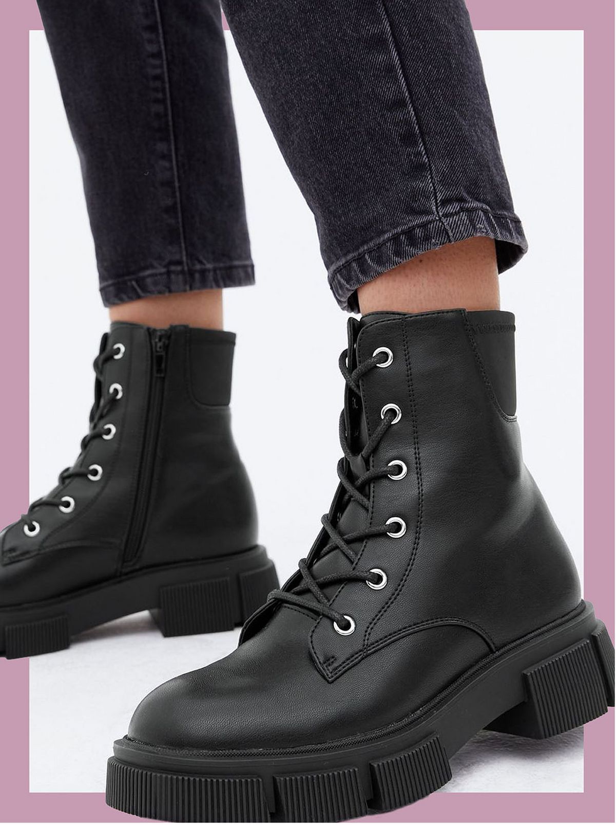 Woman wearing black lace up chunky cleated boots