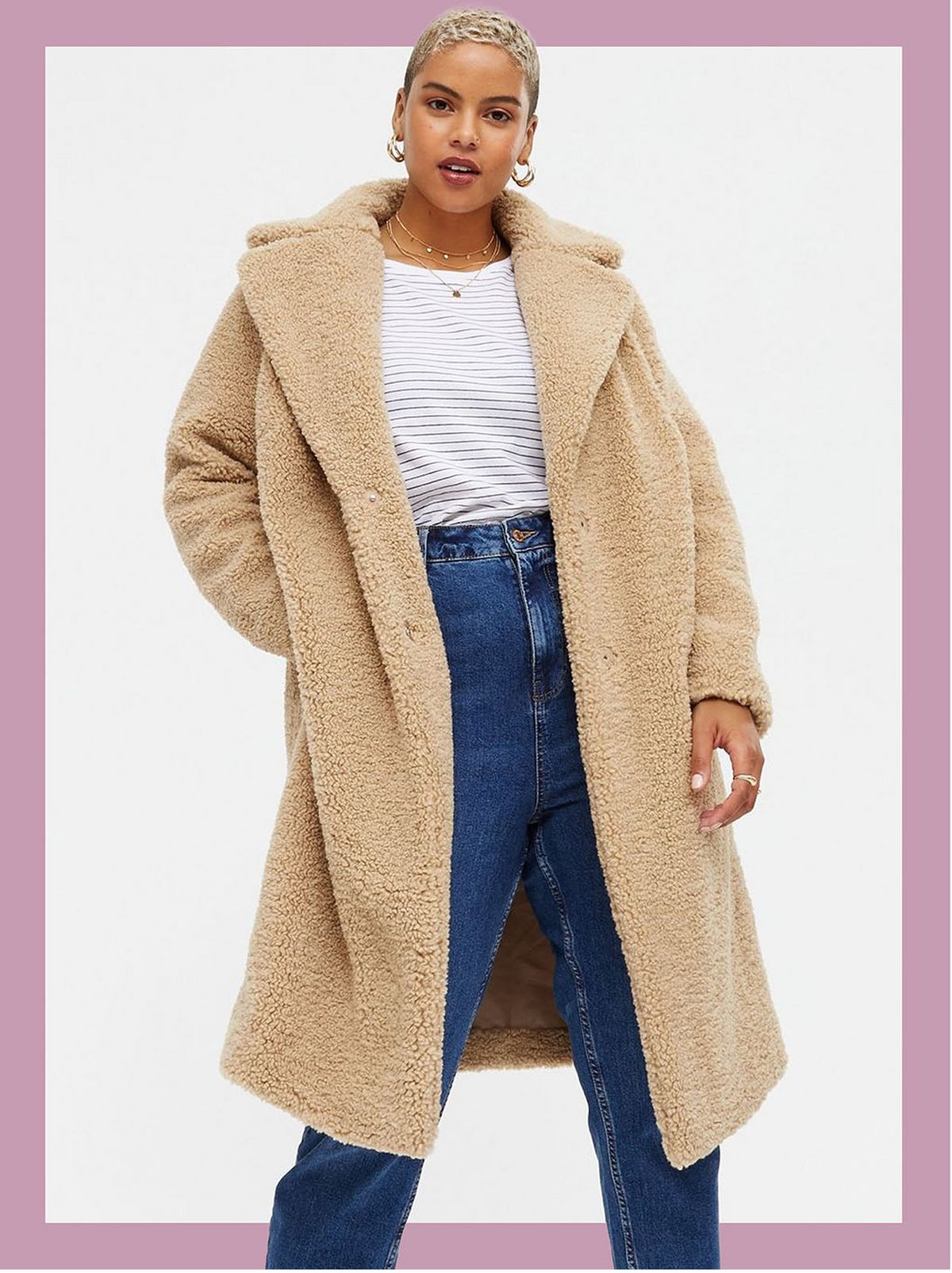 Woman wearing a camel teddy long coat, white top and jeans