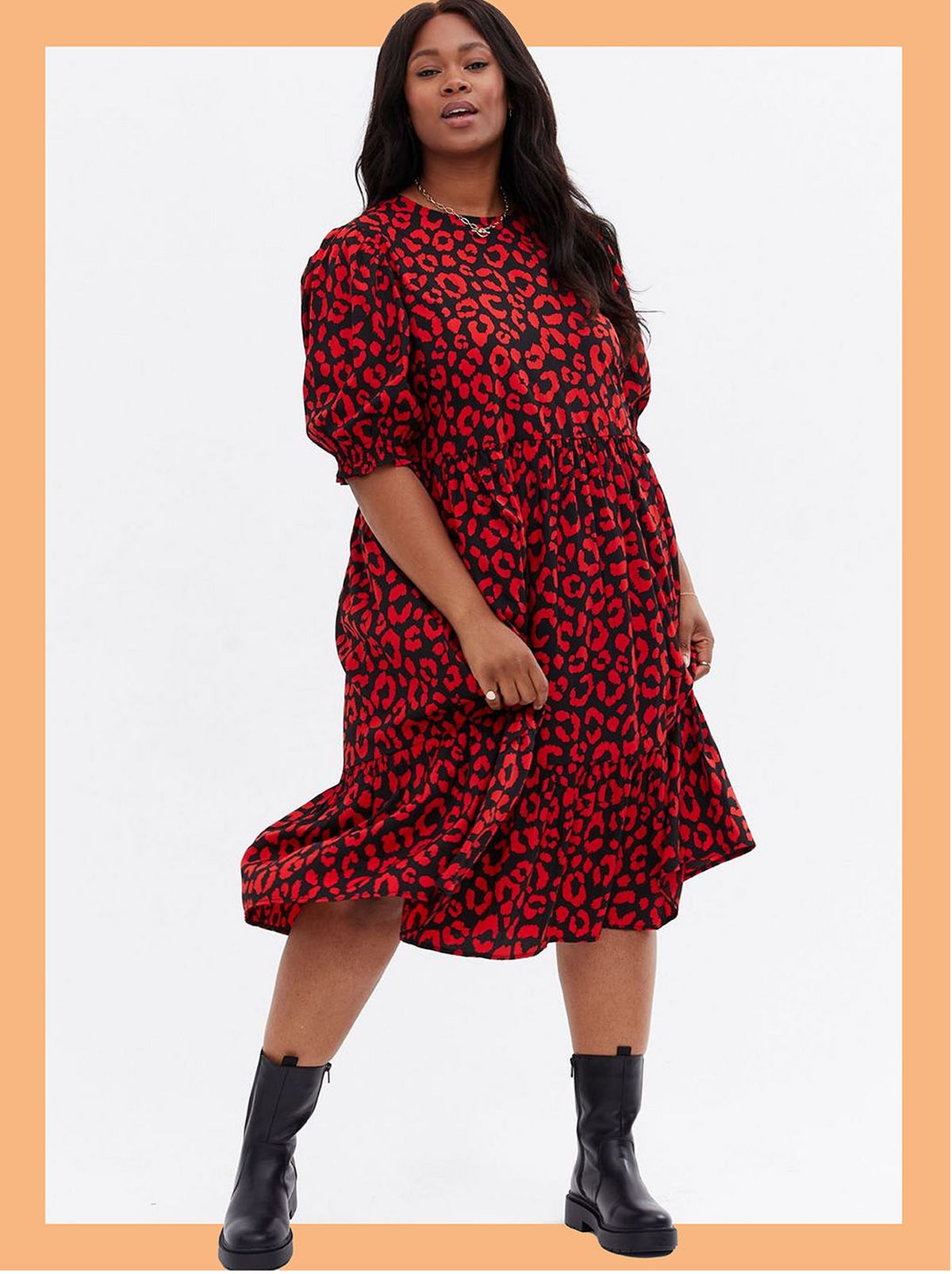 Woman wearing a black leopard print crepe midi smock dress and black boots