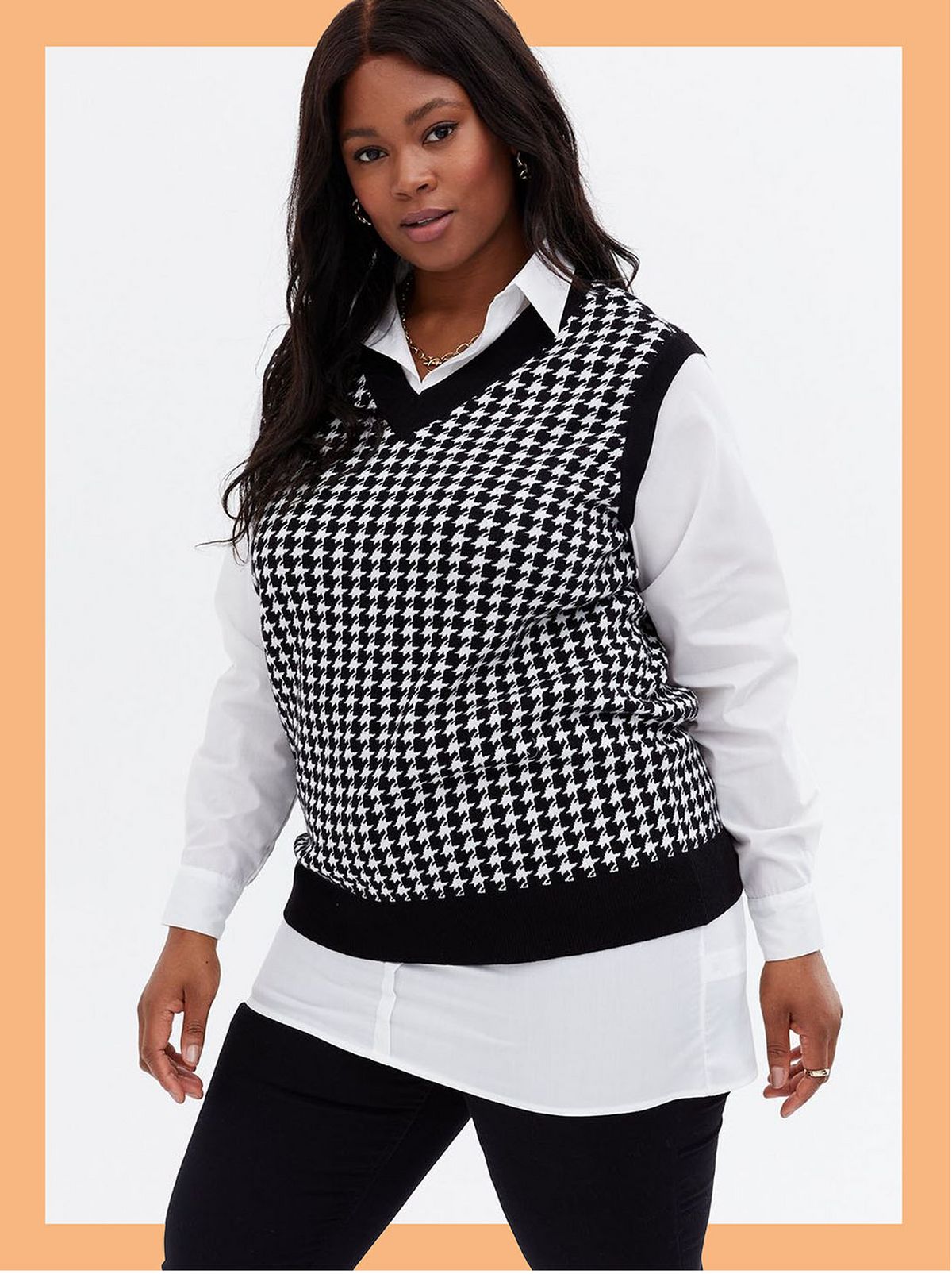 Woman wearing a black dogtooth vest jumper shirt and trousers
