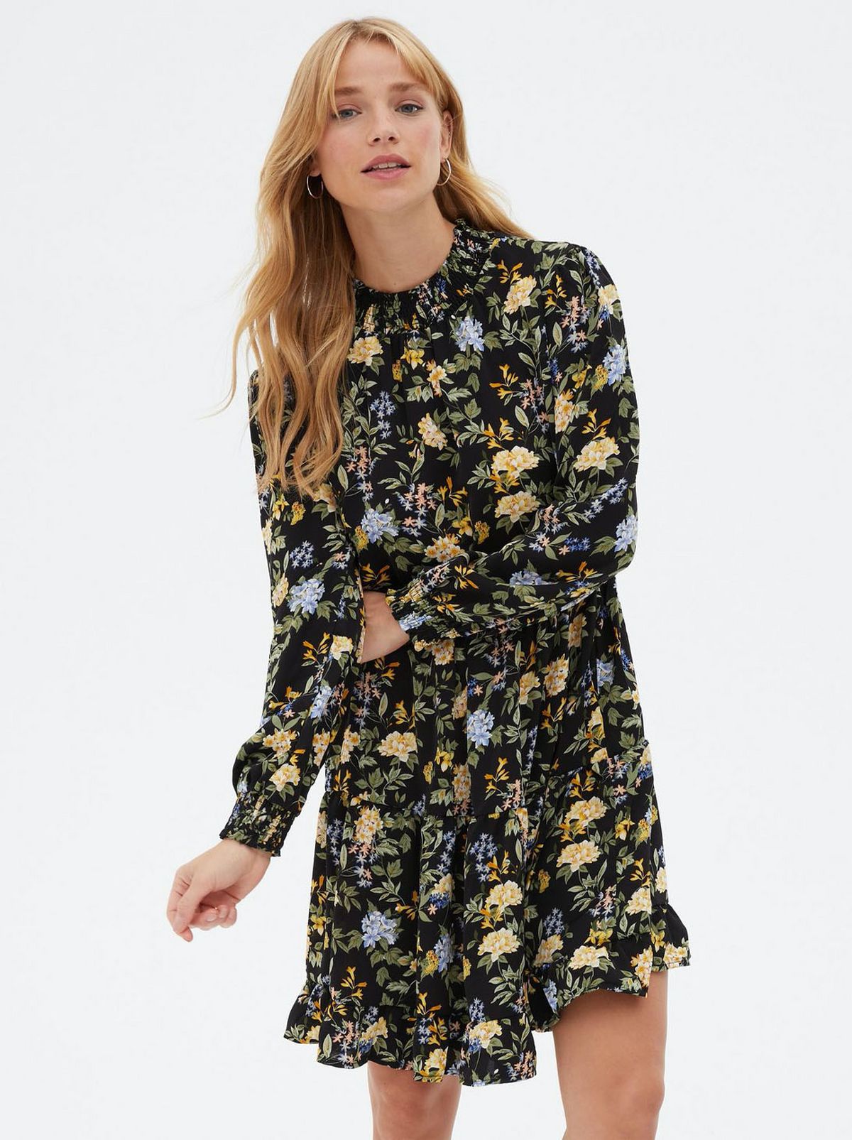 Woman wearing a black floral shirred high neck mini dress