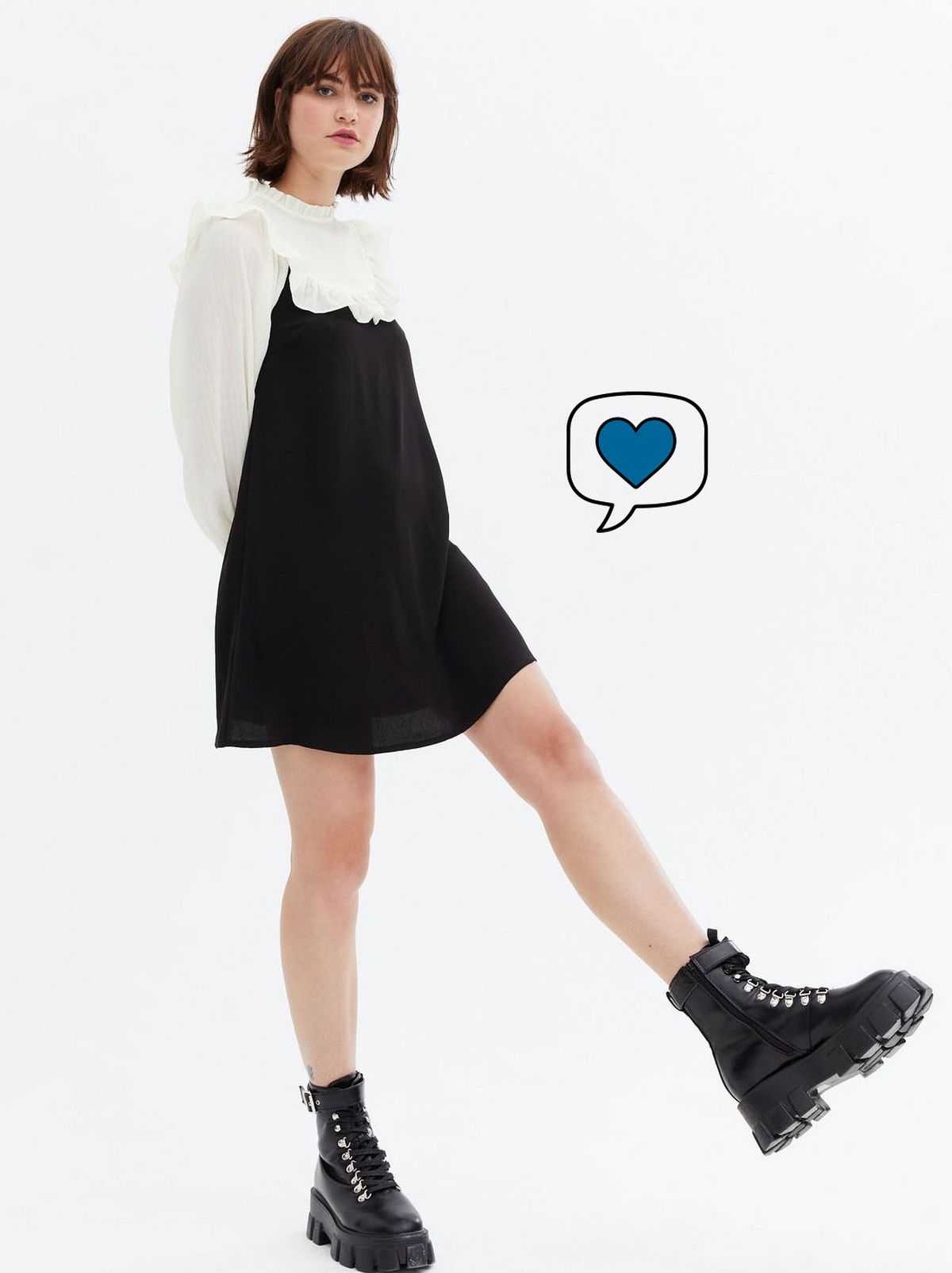 Woman wearing a black yoke mini smock dress