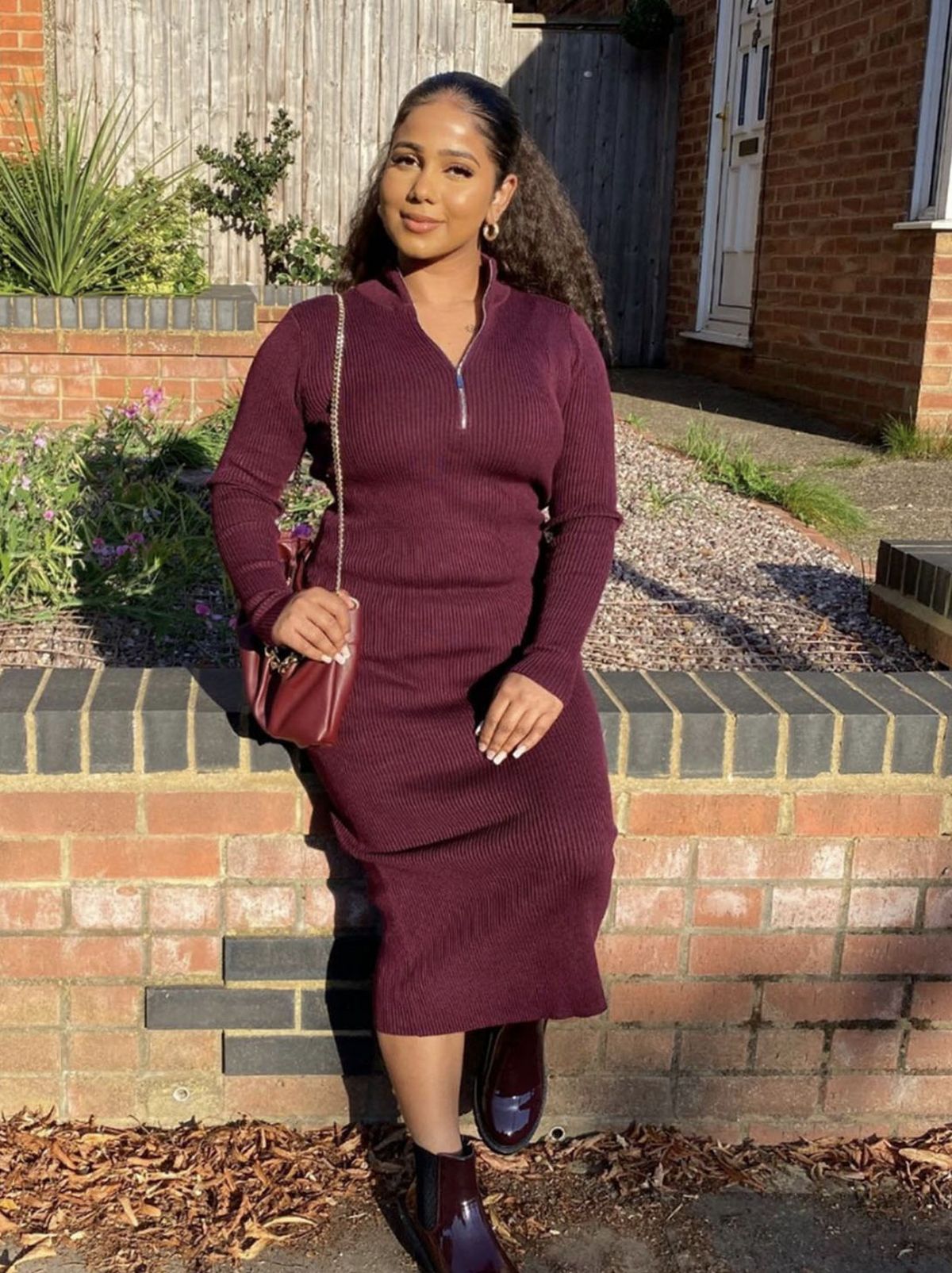 New Look's Shanuja wearing a burgundy ribbed knit midi dress