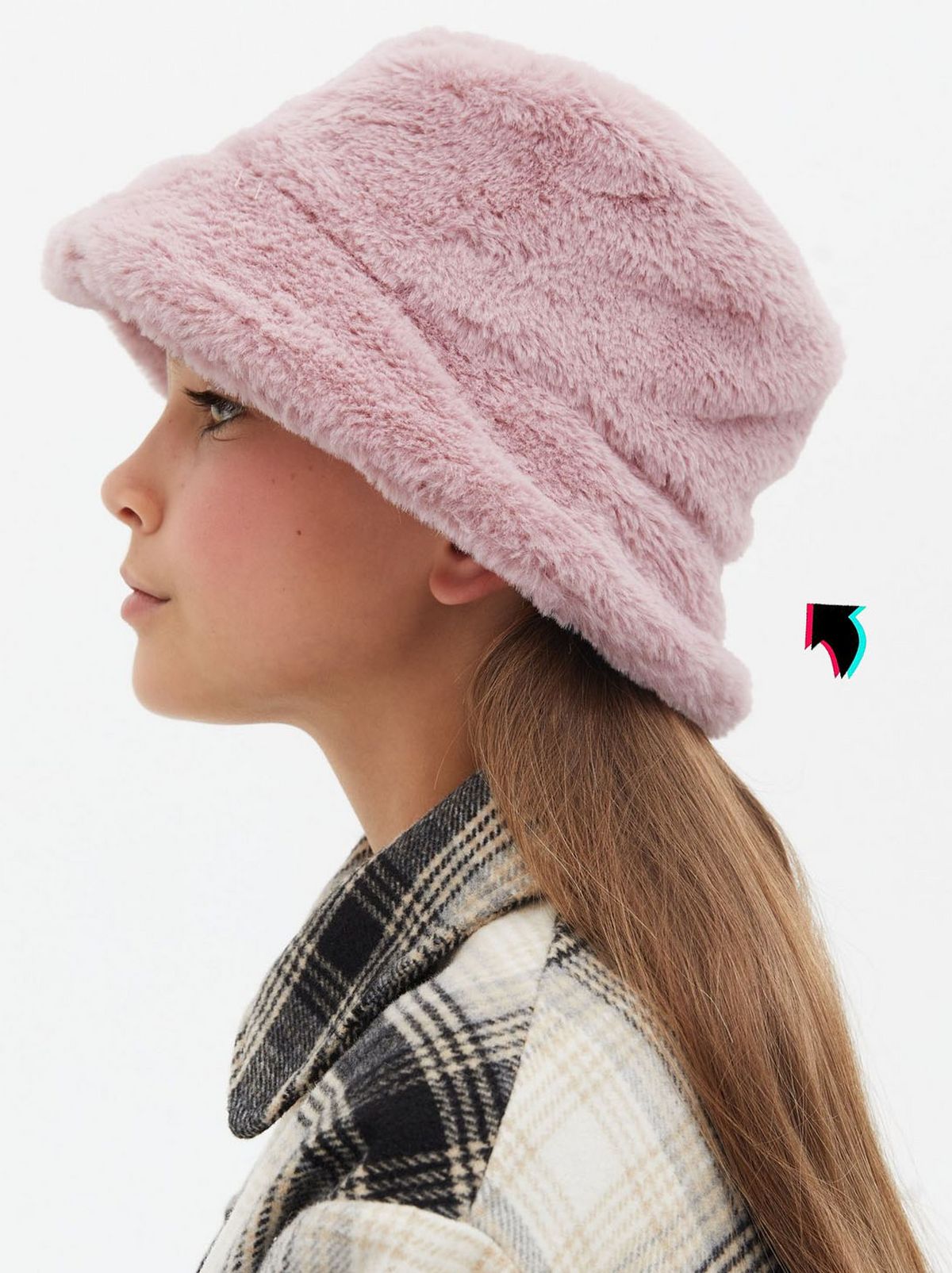 Girl wearing a pink faux fur bucket hat	