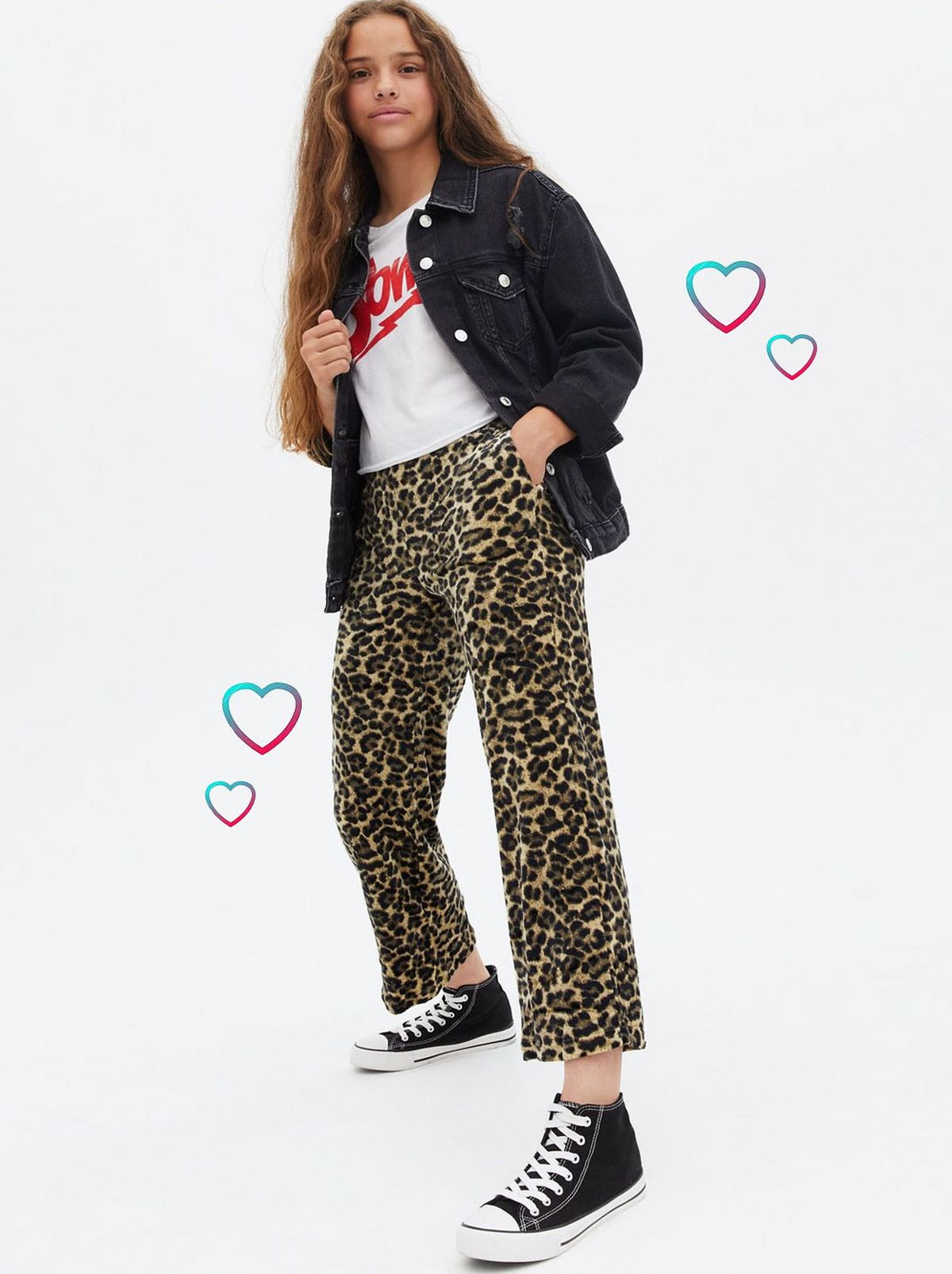 Girl wearing leopard print wide leg joggers, jacket, t-shirt and trainers