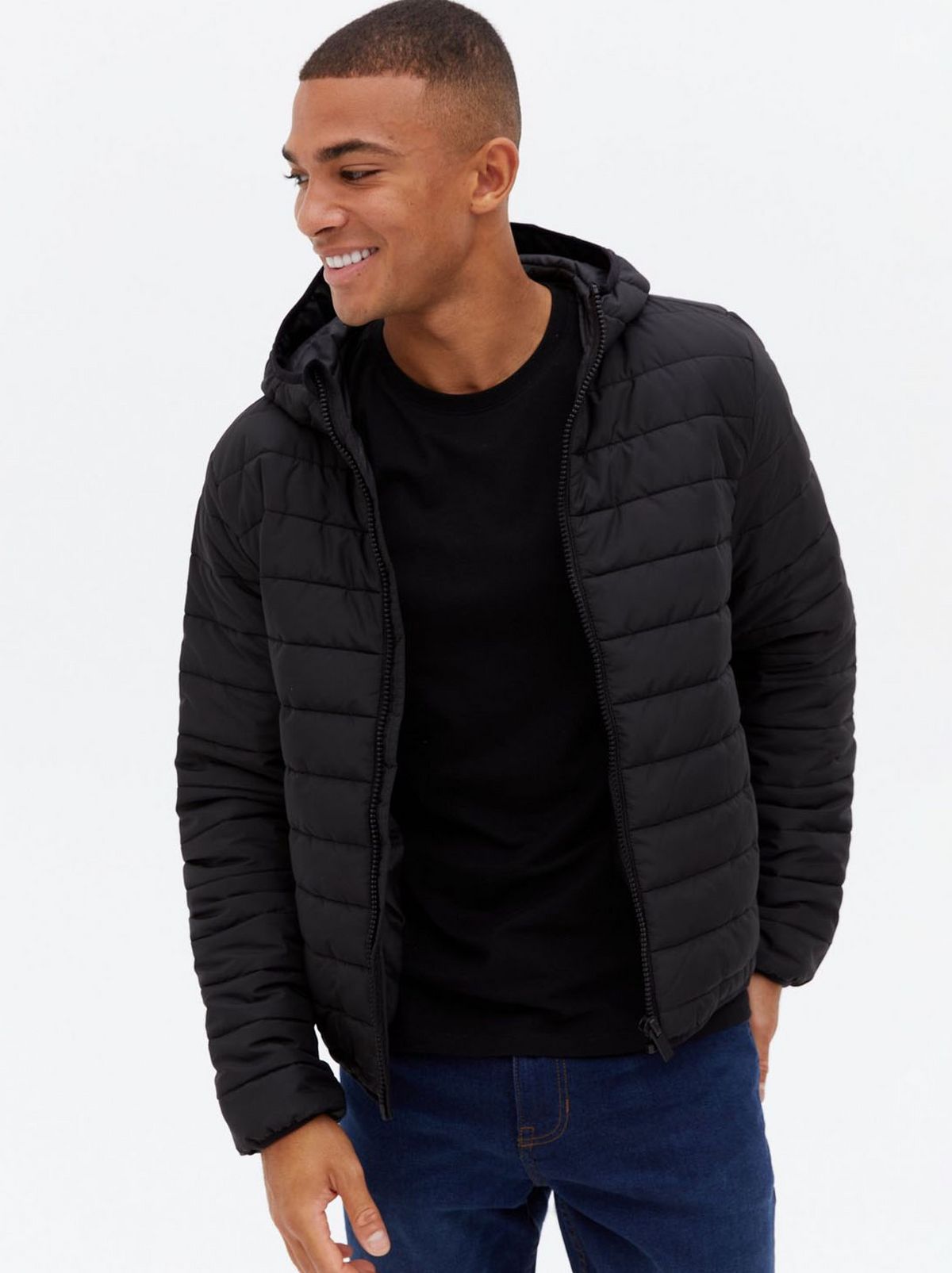 Man wearing a black hooded puffer jacket