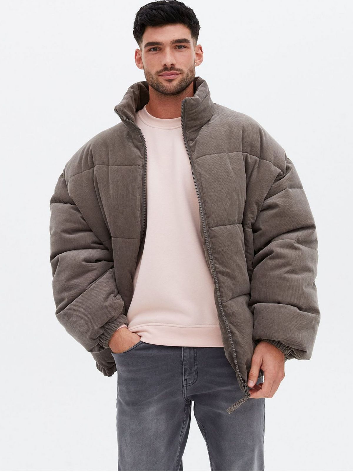 Man wearing a stone oversized puffer jacket 