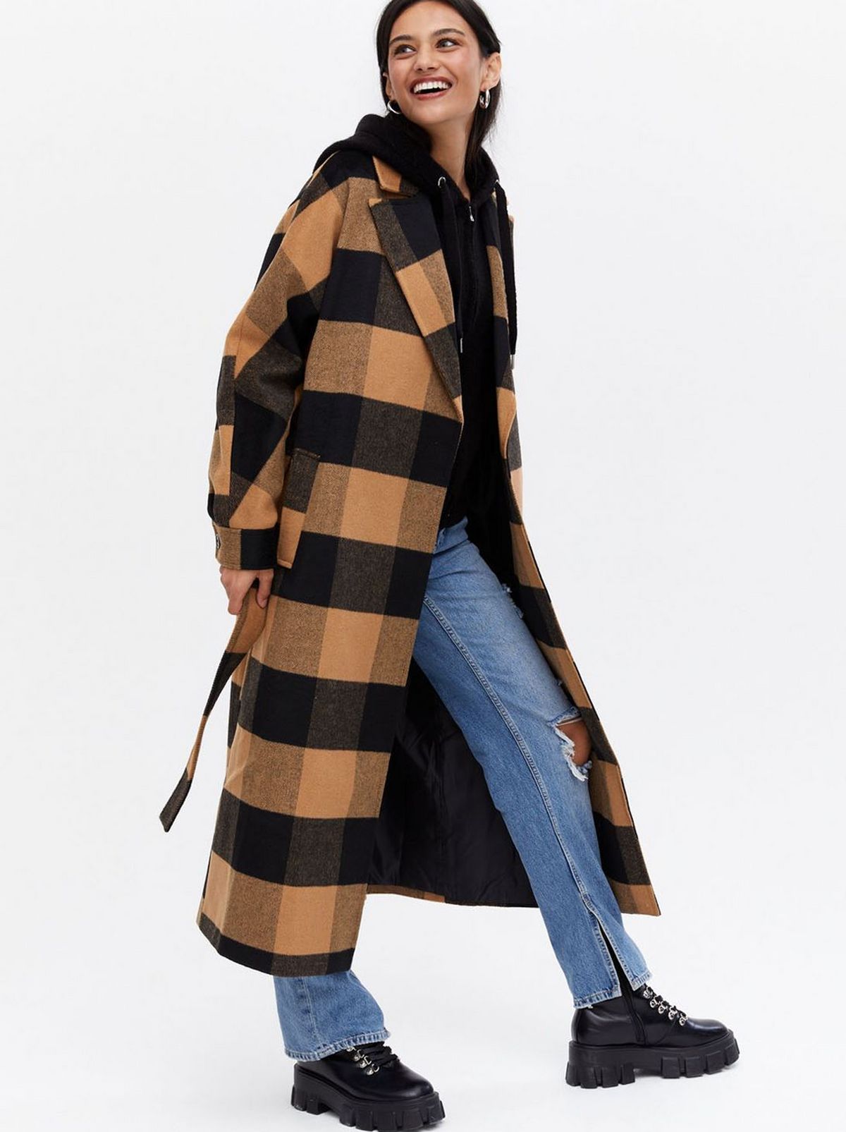 Woman wearing a camel gingham belted long coat	
