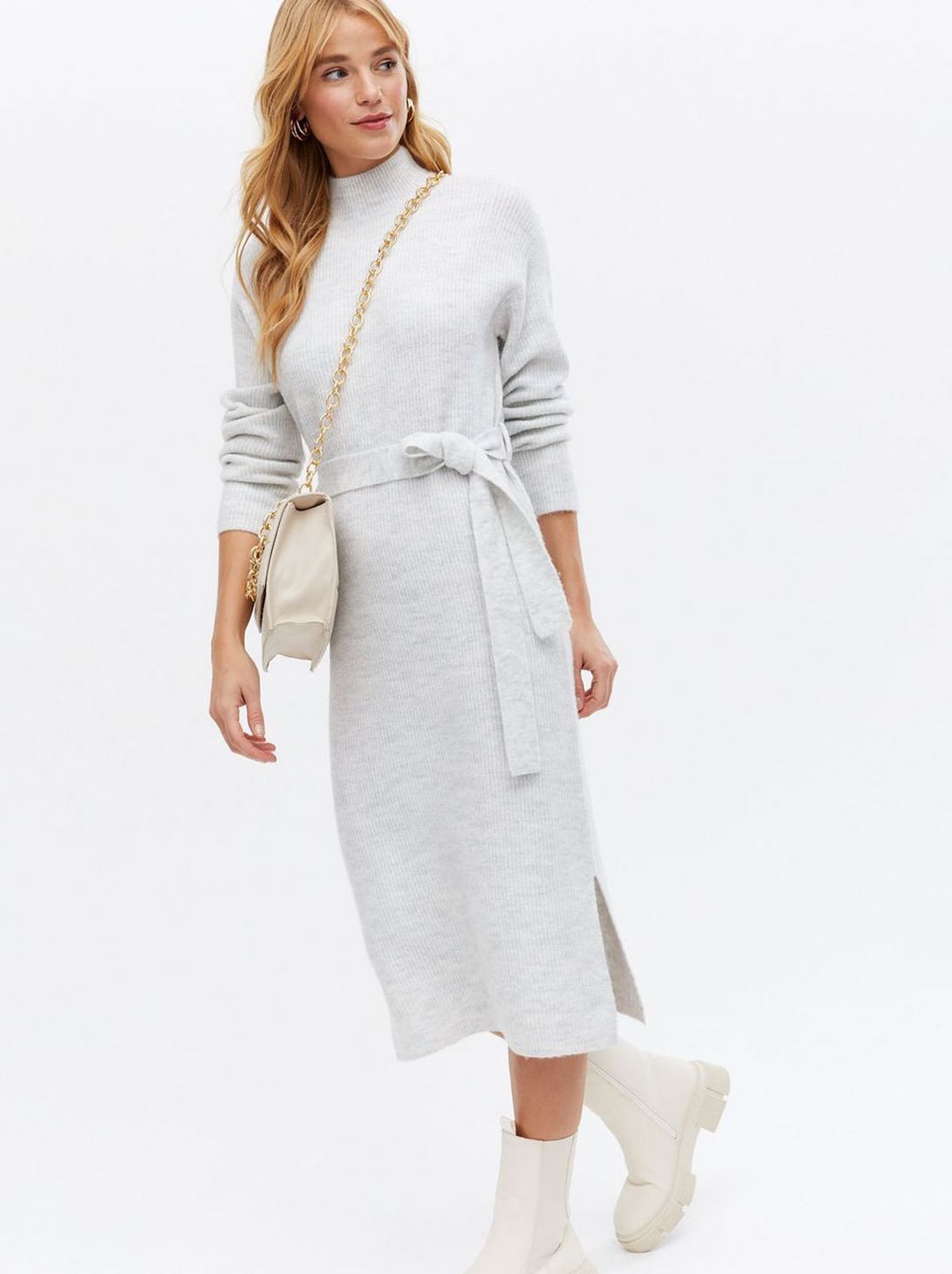 Woman wearing a pale grey knit midi jumper dress	