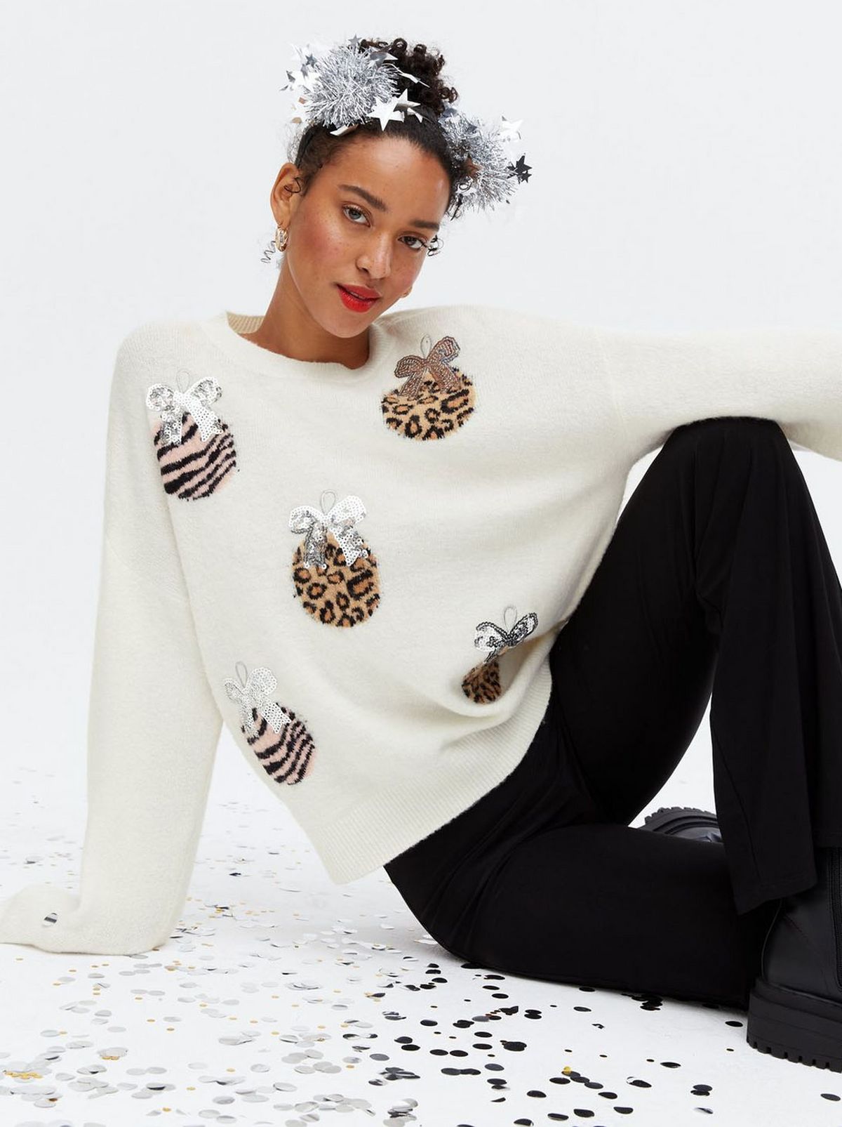Woman wearing a white animal print Christmas jumper	