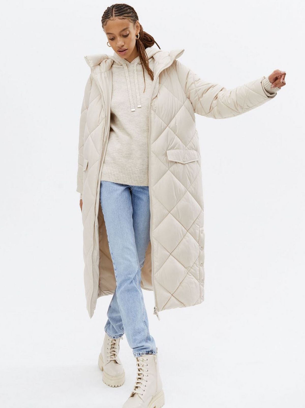 Woman wearing a stone quilted puffer coat	