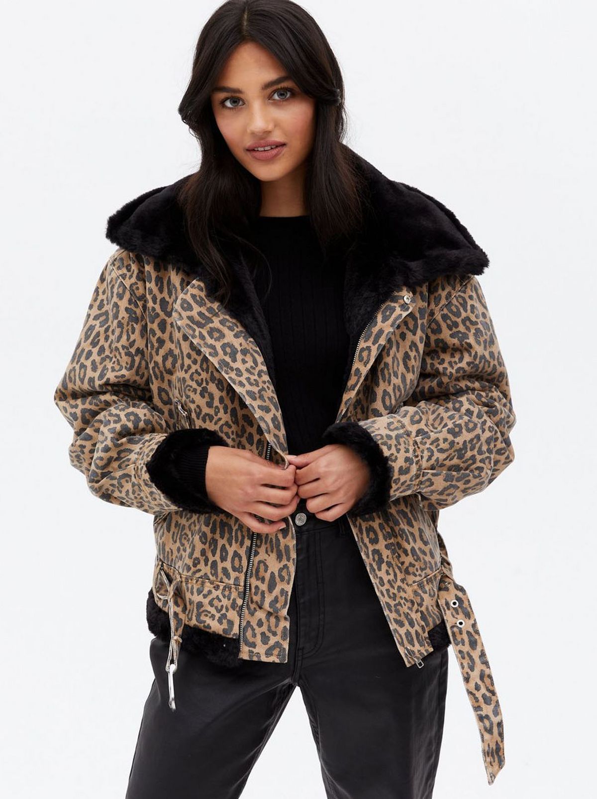 Woman wearing a brown leopard print denim jacket	