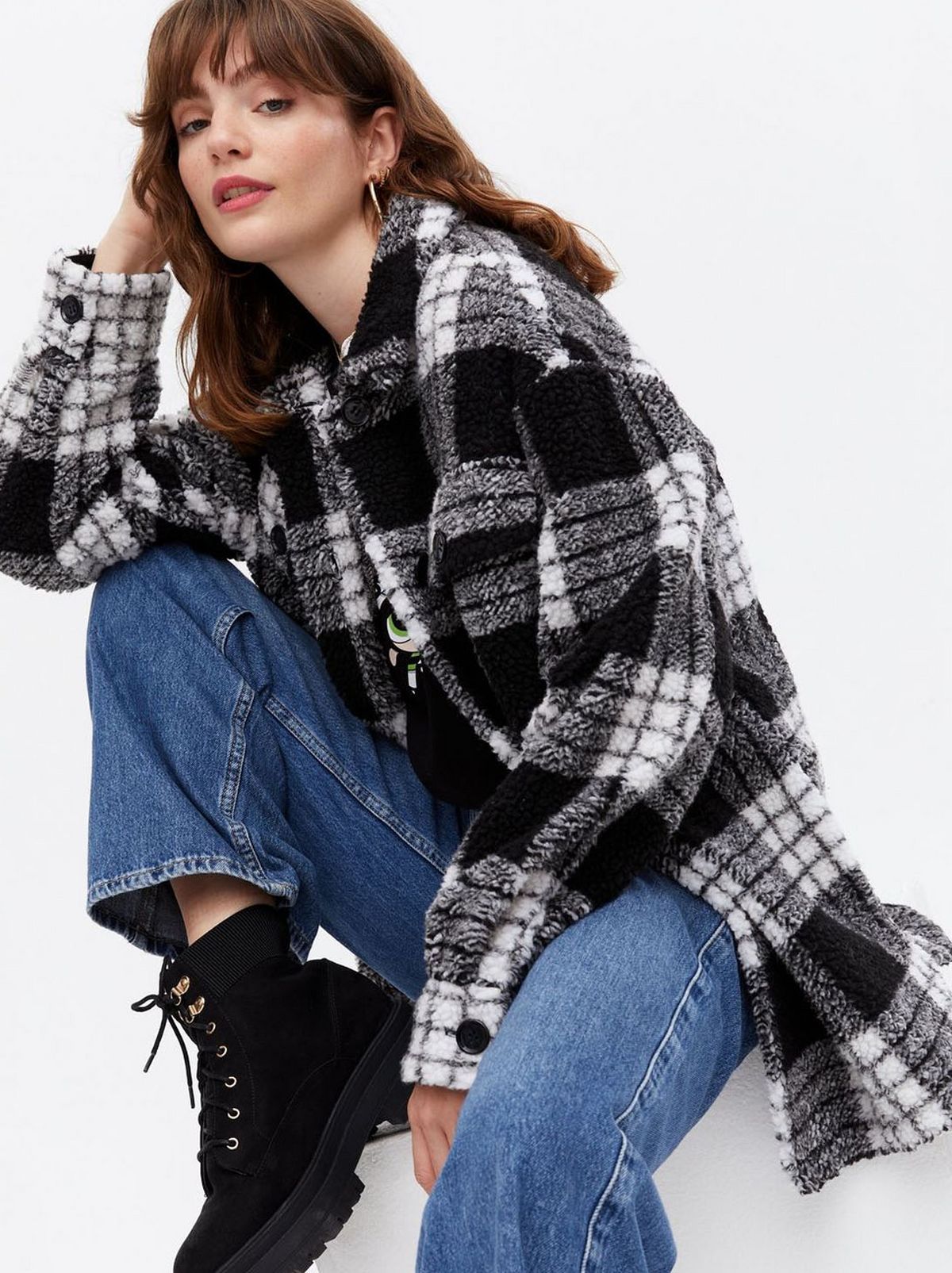 Woman wearing a black check teddy shacket	