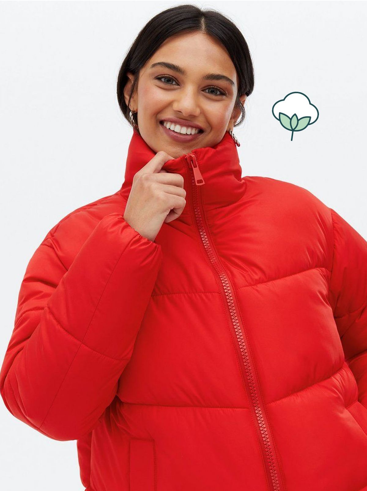 Woman wearing a red boxy puffer jacket
