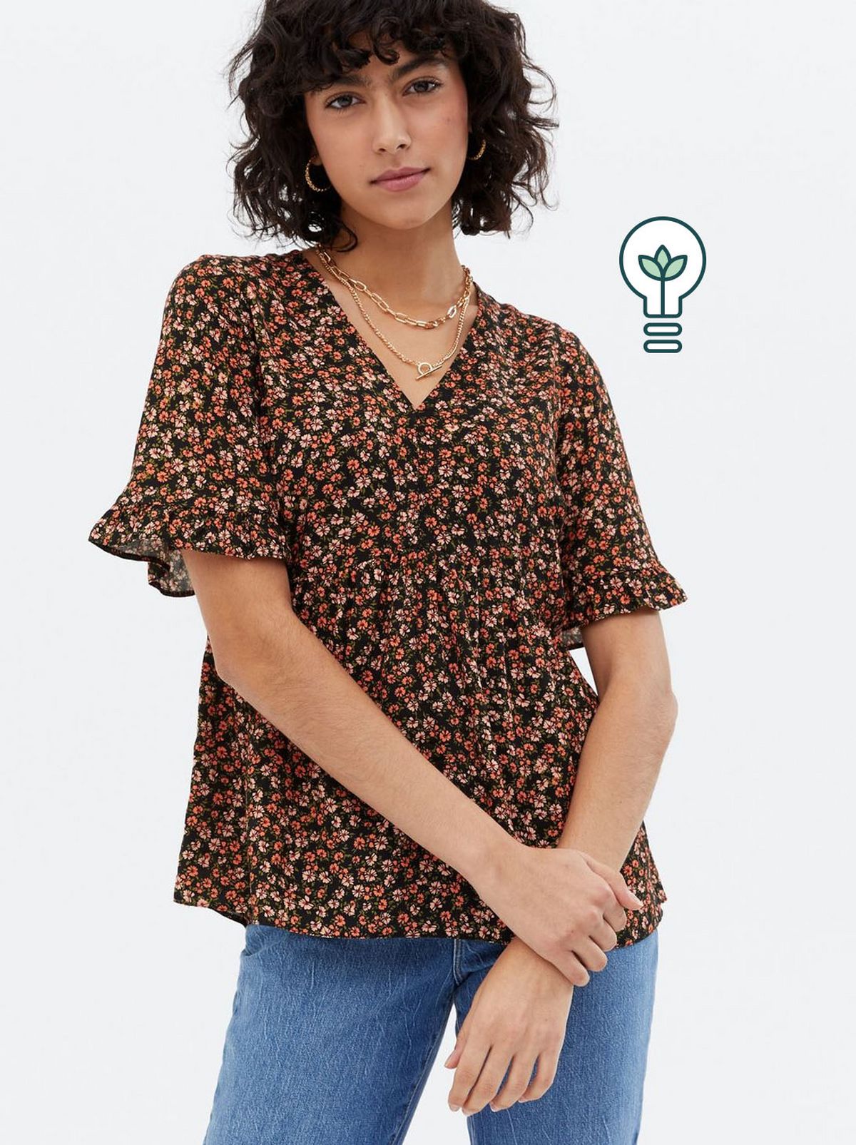 Woman wearing a black disty floral peplum top