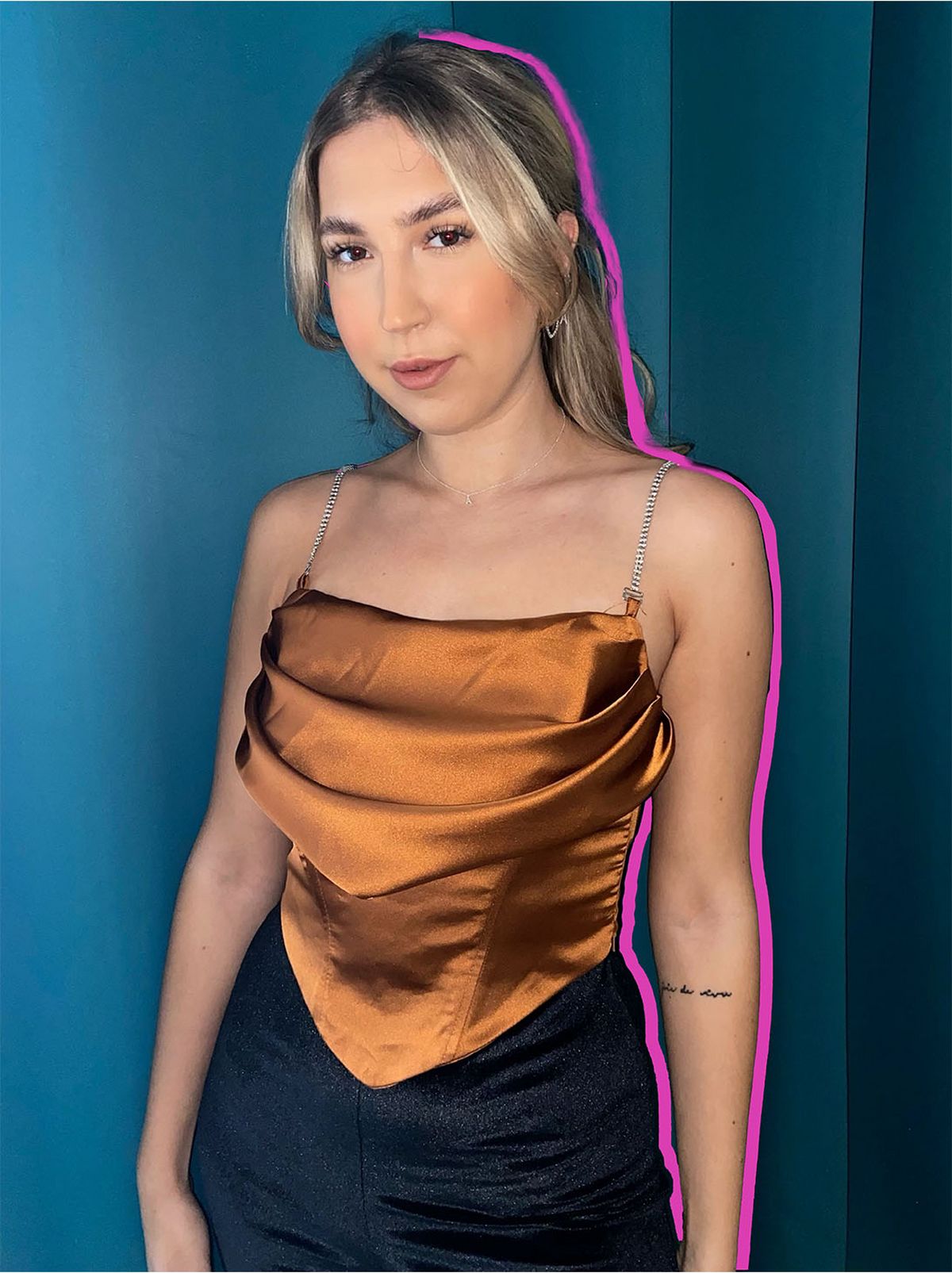 Agata wearing a sleeveless satin camel top	