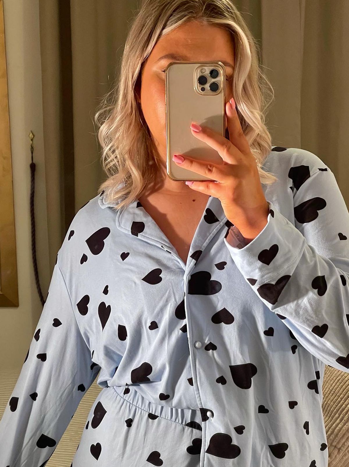 New Look's Lauren c wearing a black heart blue shirt and trousers pyjama set	