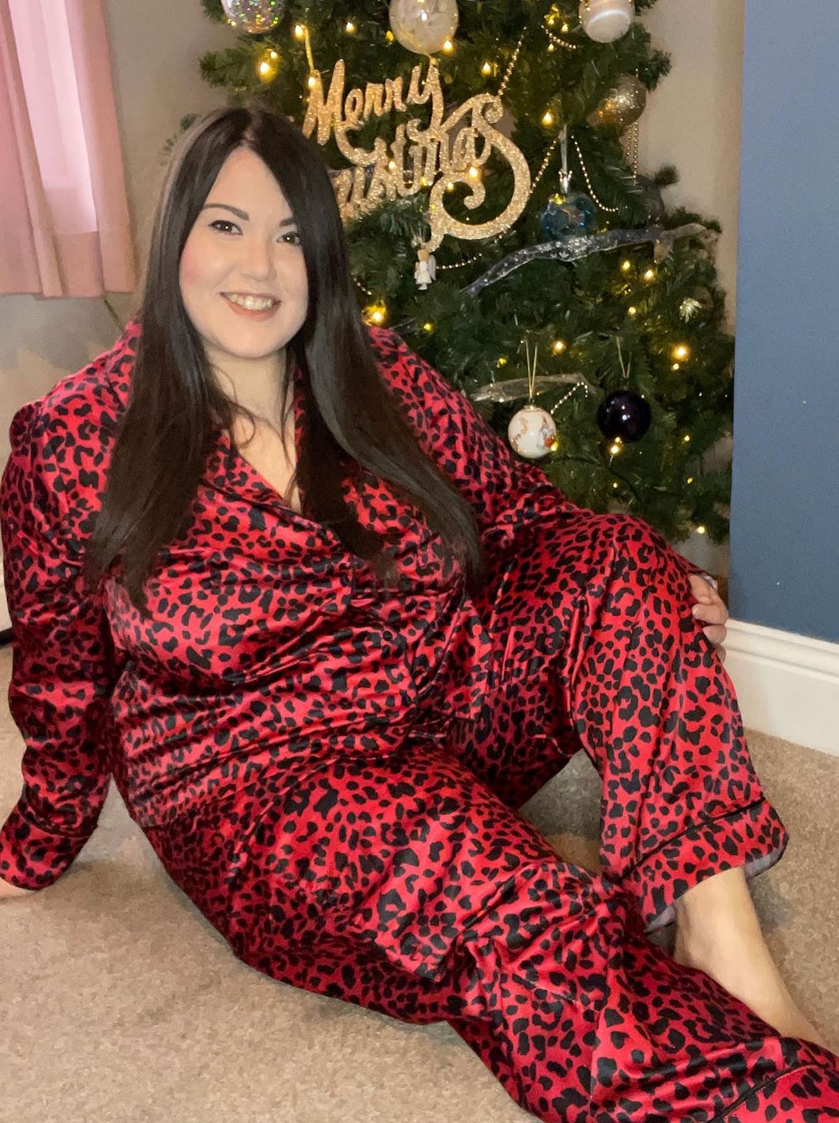 New Look's Laura h wearing a red leopard print shirt and trousers pyjama set	