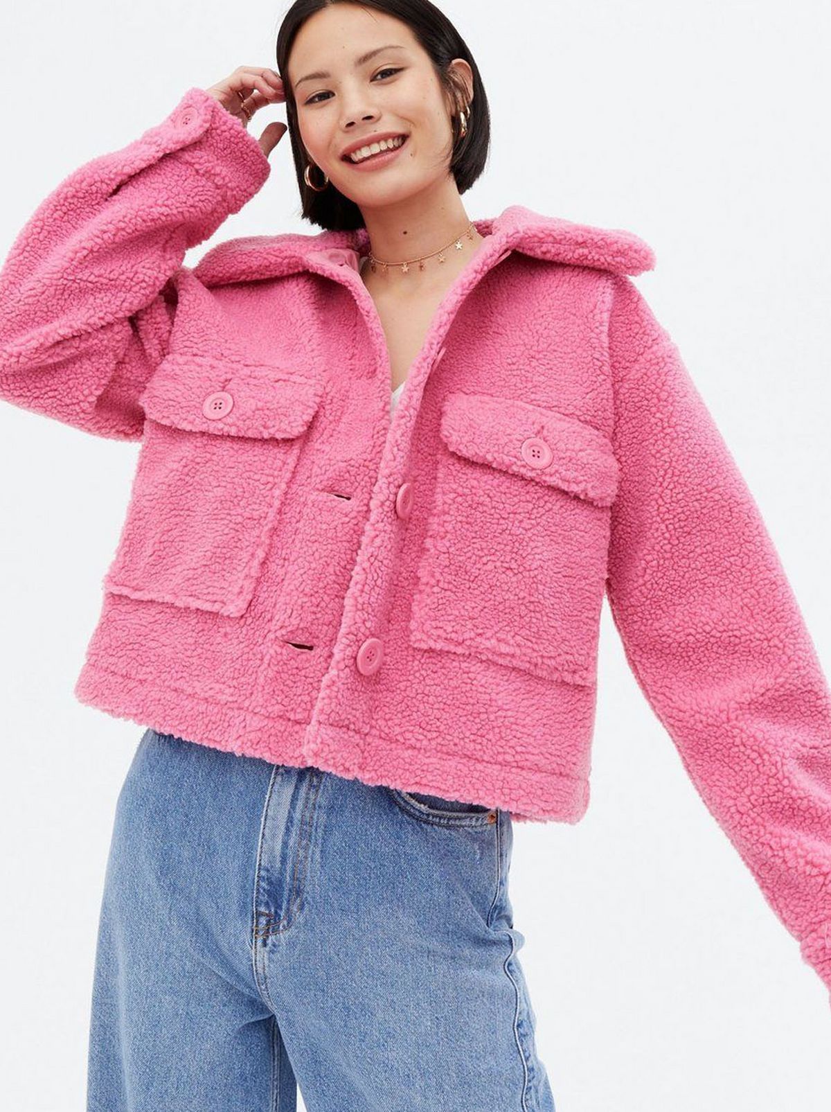 Woman wearing a bright pink teddy jacket