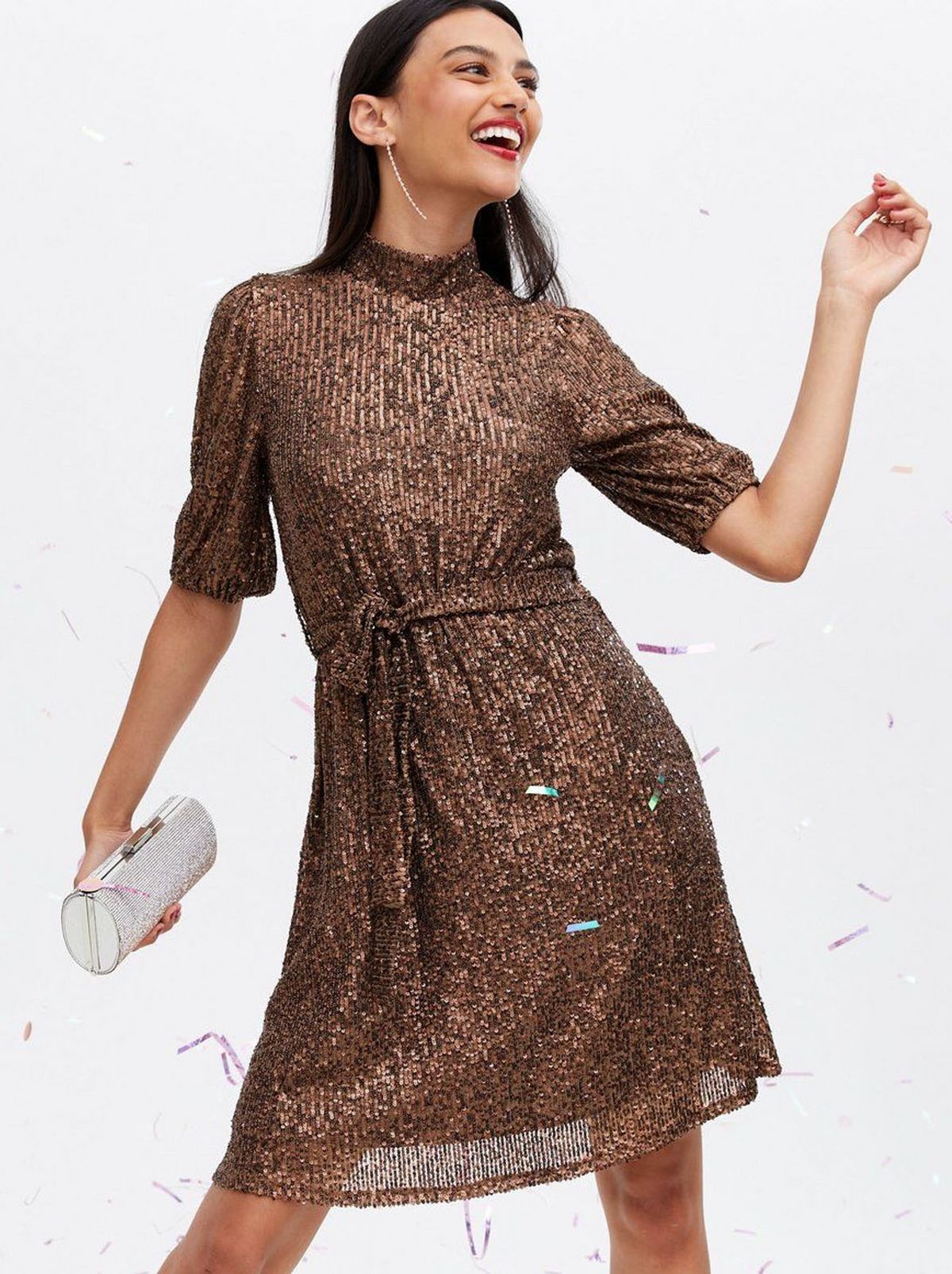 Woman wearing a sequin high neck tunic dress