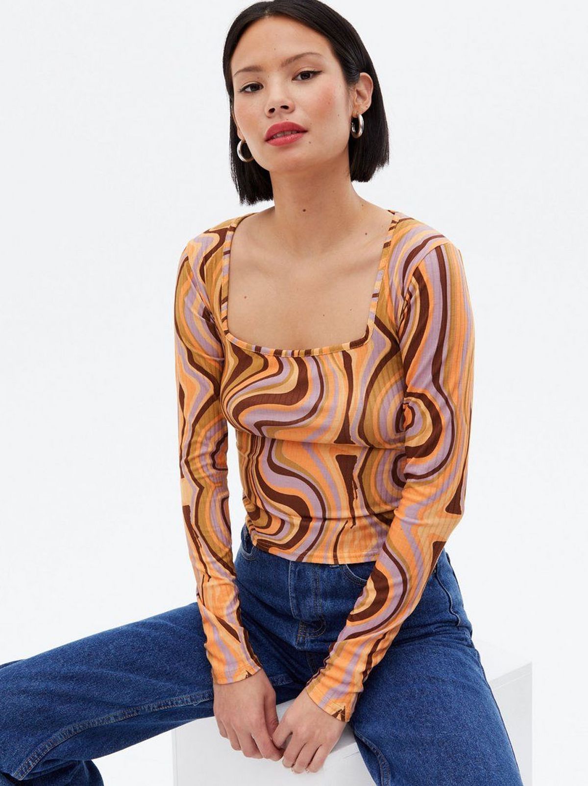 Woman wearing a multi-coloured swirl patterned top