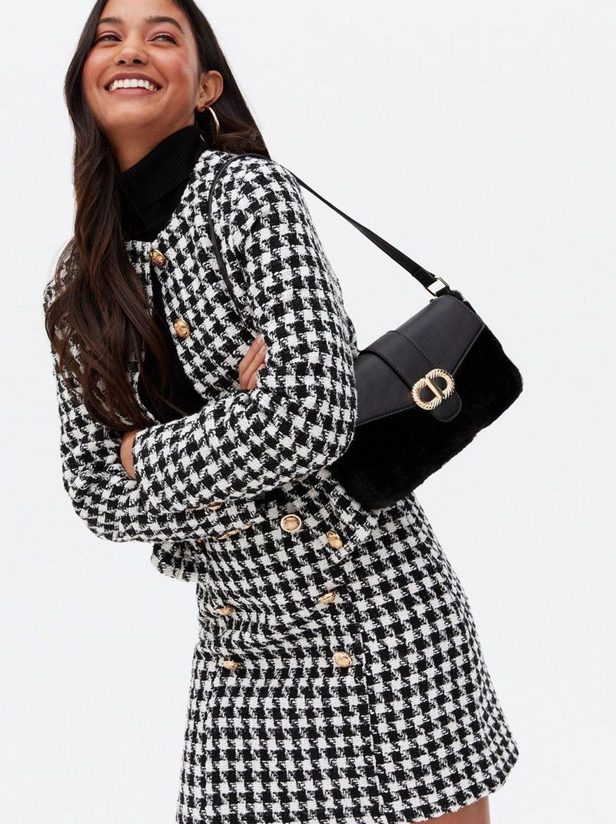Woman carrying a black faux fur shoulder bag