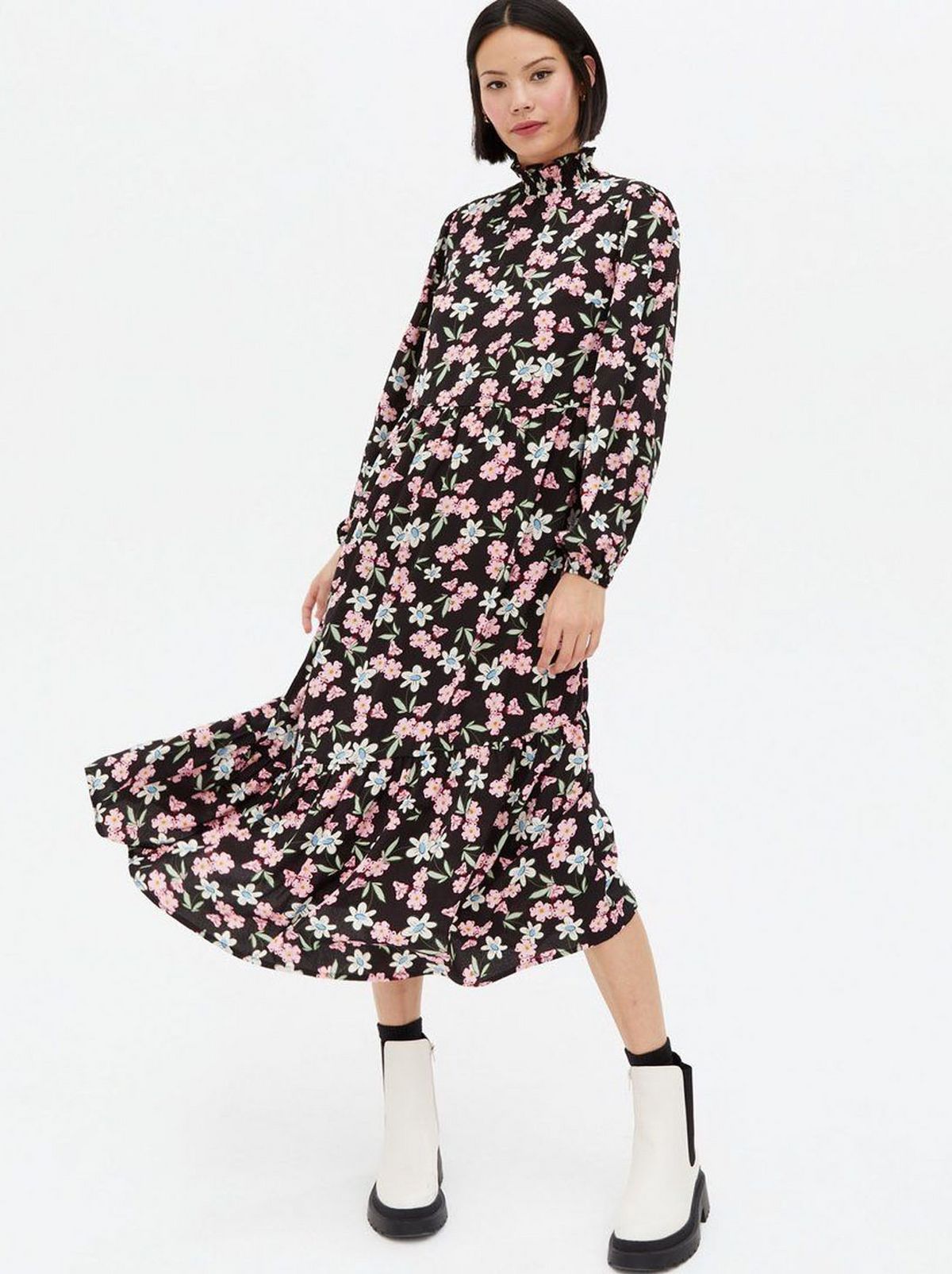 Woman wearing a black floral high neck smock dress