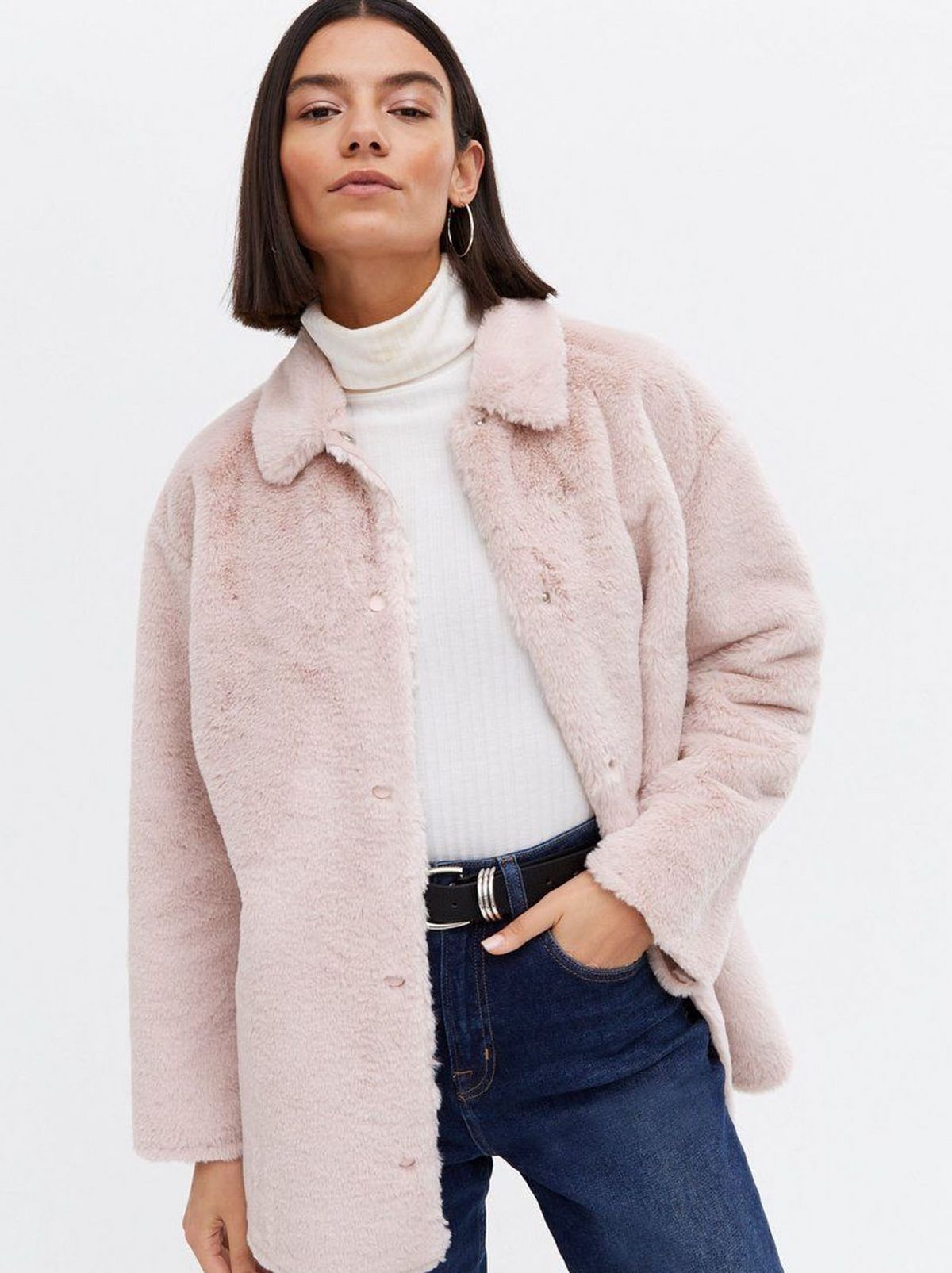 Woman wearing a pale pink faux fur shacket