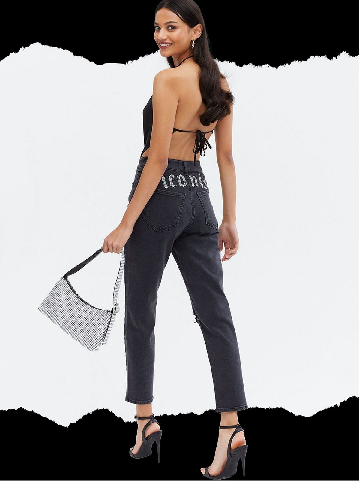 Woman wearing a black diamanté iconic logo jeans