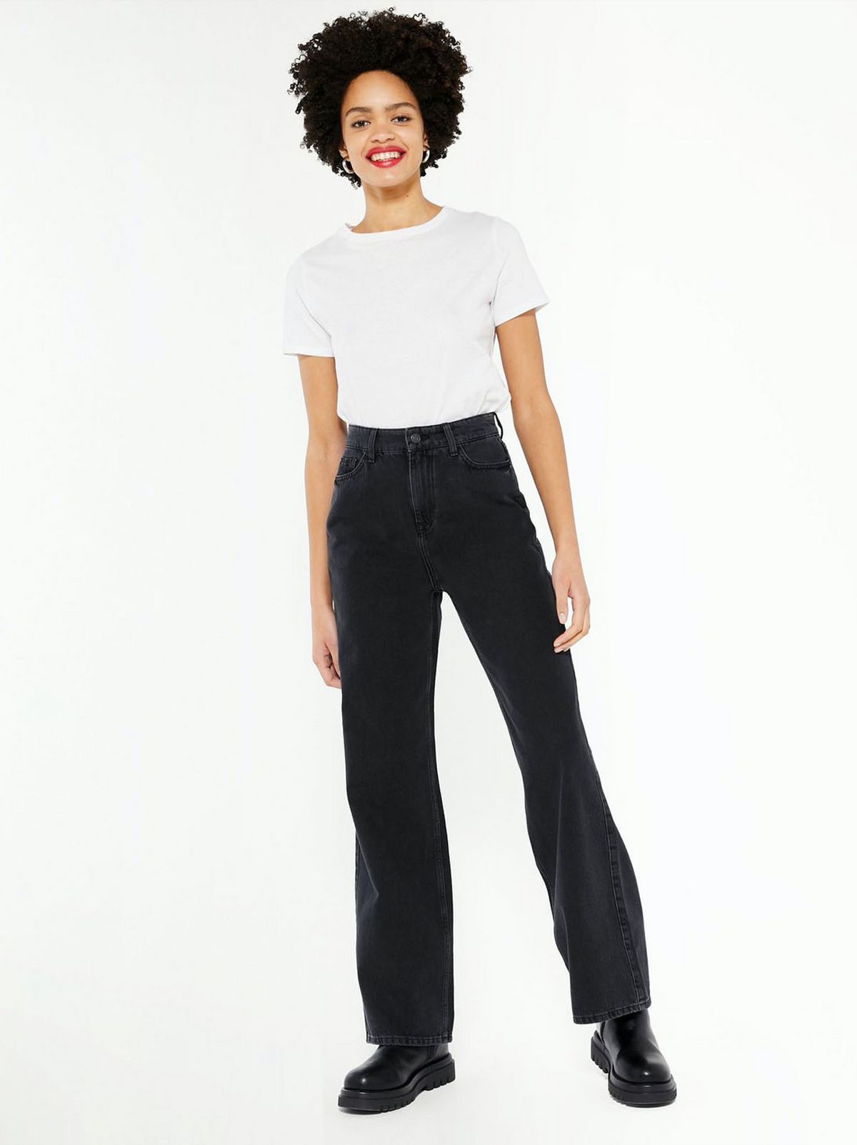 model wears white t-shirt and black wide leg jeans