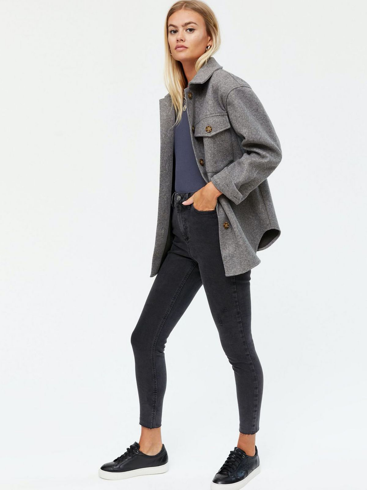 model wears shacket and black skinny jeans