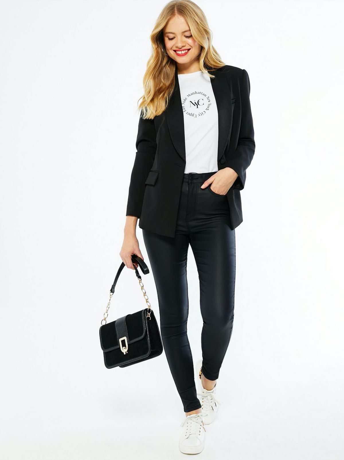 model wears black leather look jeans with white tee and black blazer