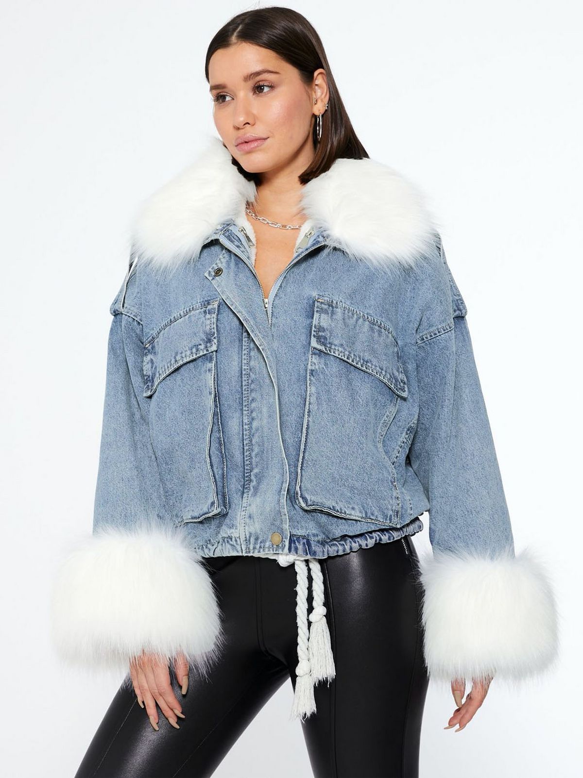 model wears blue denim jacket with white faux fur trim
