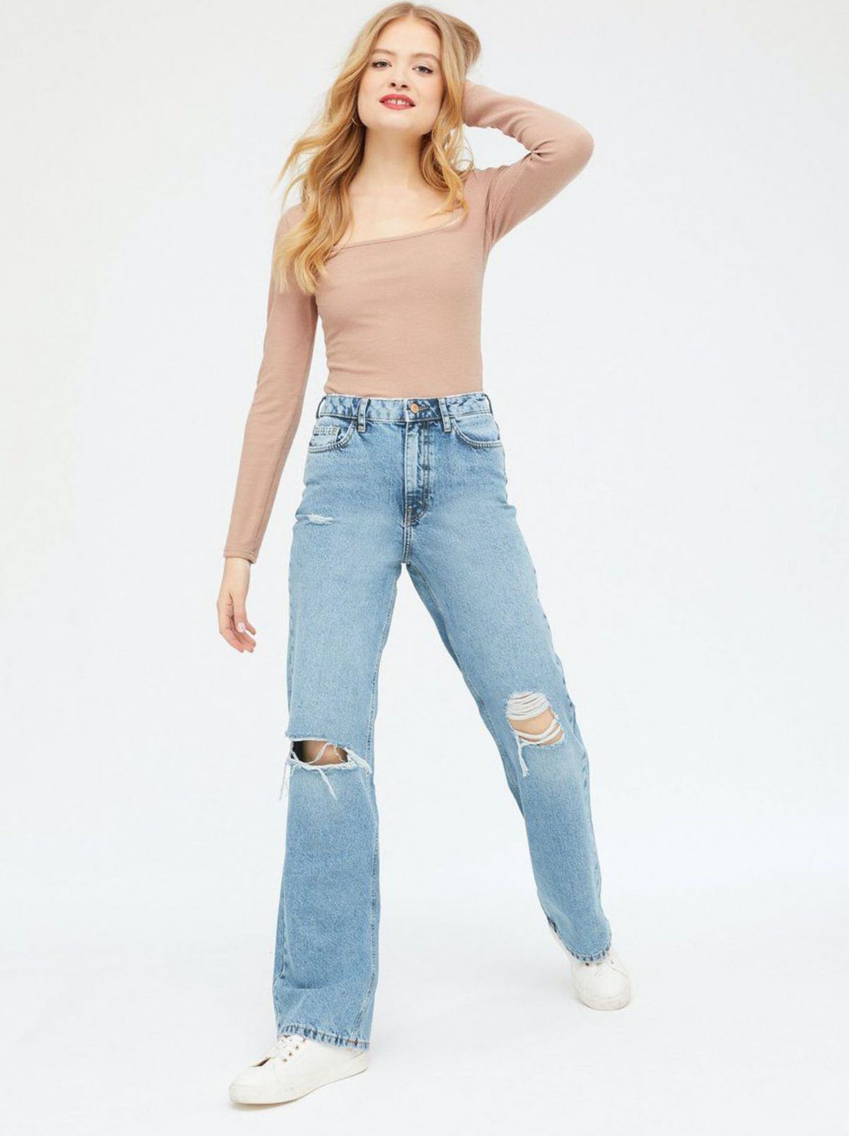 Woman wearing a long sleeve top and Baggy Fit Jeans Womens