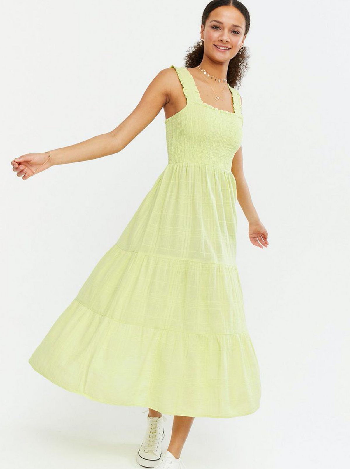 Woman wearing a Green Tiered Midi Dress