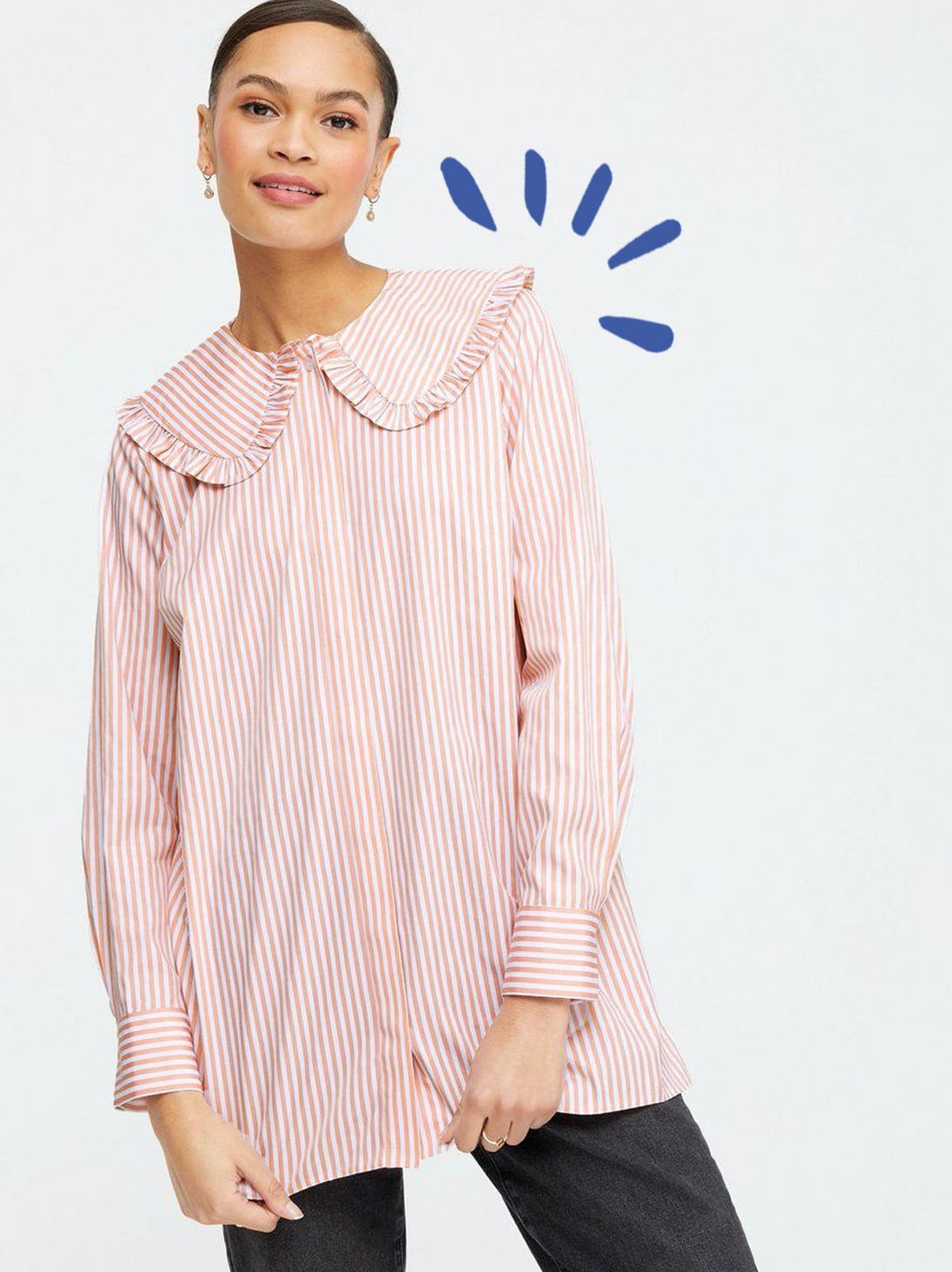 Woman wearing a rust stripe frill collar long shirt and dark grey jeans