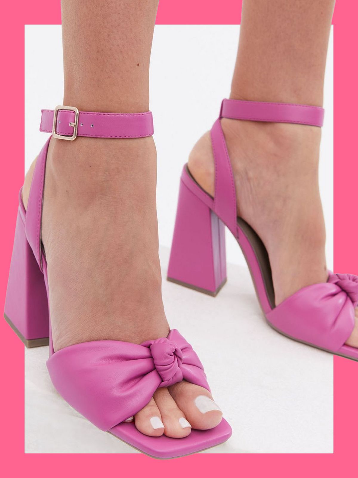 Woman wearing pink knot block heels sandals