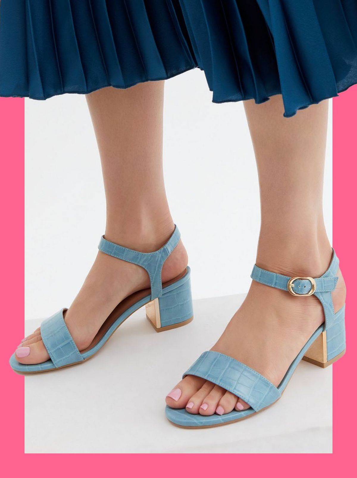 Woman wearing blue faux croc heel sandals