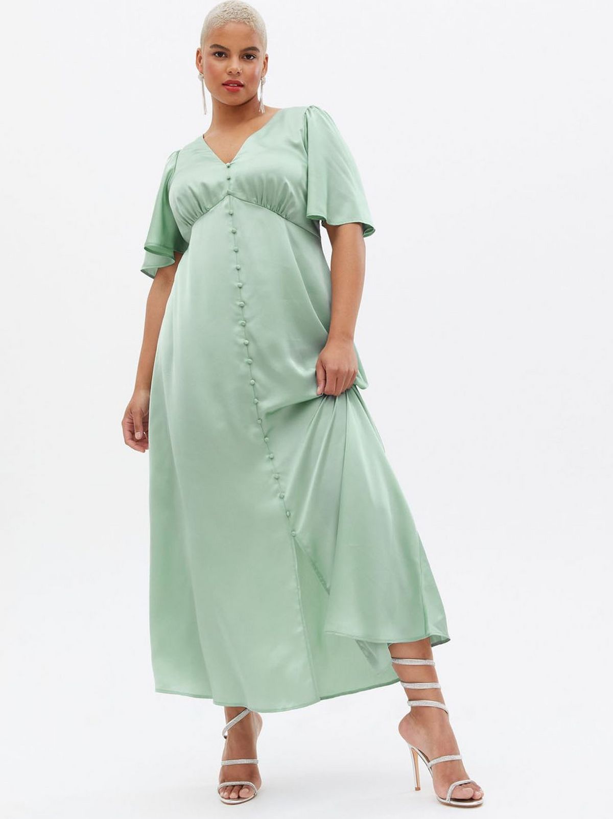 Woman wearing a green satin sleeve front button midi dress