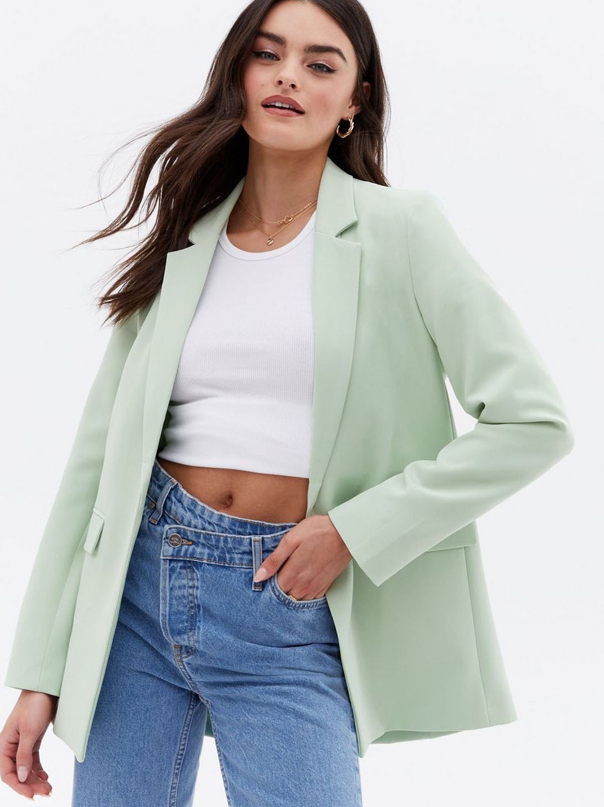 Woman wearing a light green relaxed fit blazer