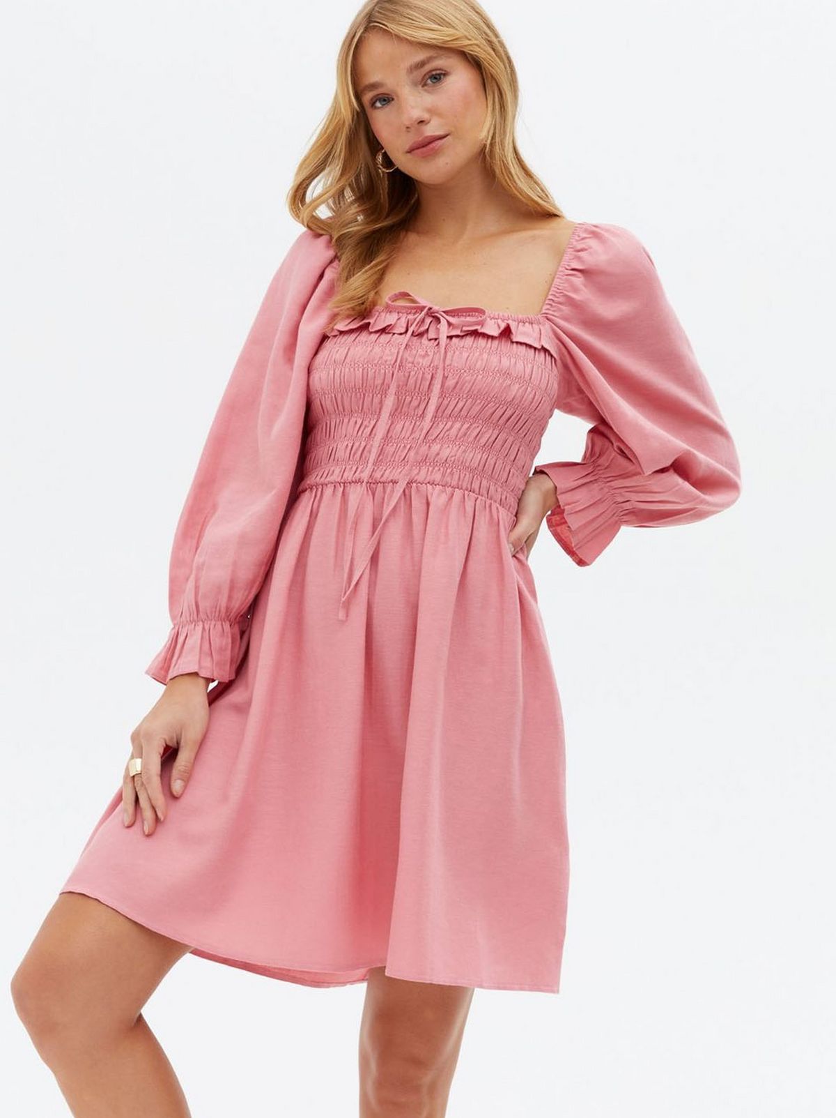 Woman wearing a blue tiered mini oversized smock dress