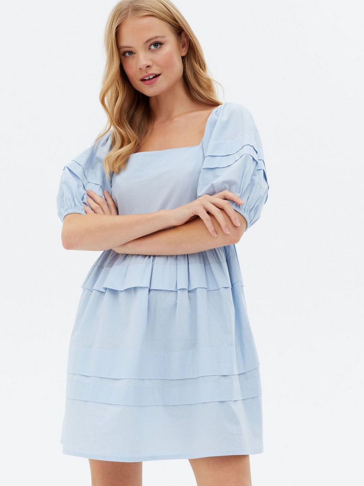 Woman wearing a blue tiered mini oversized smock dress