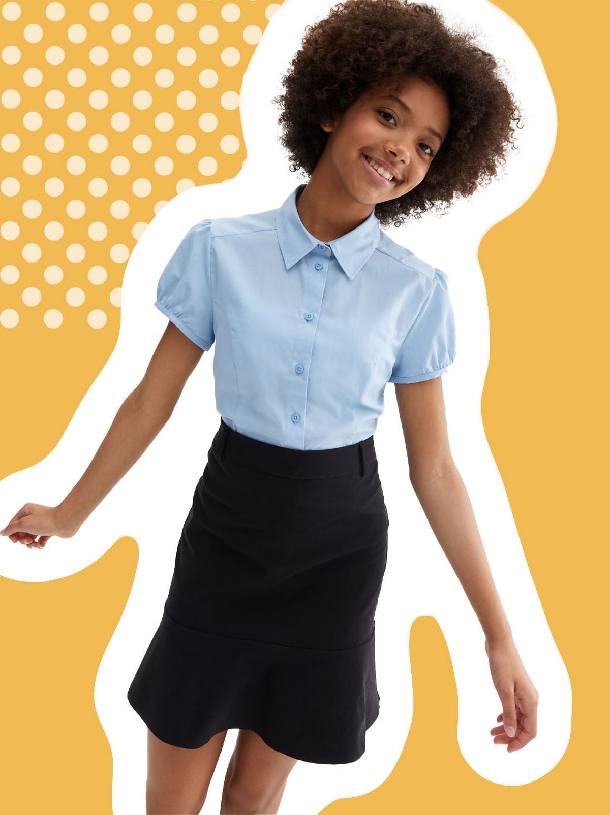 A girl smiling into the camera in front of a blank wall wearing a puff sleeve school shirt