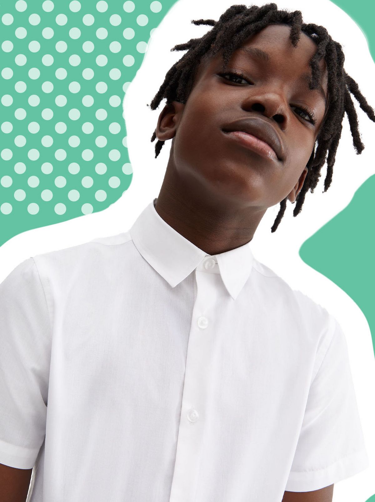 A boy stares at the camera wearing a white school shirt