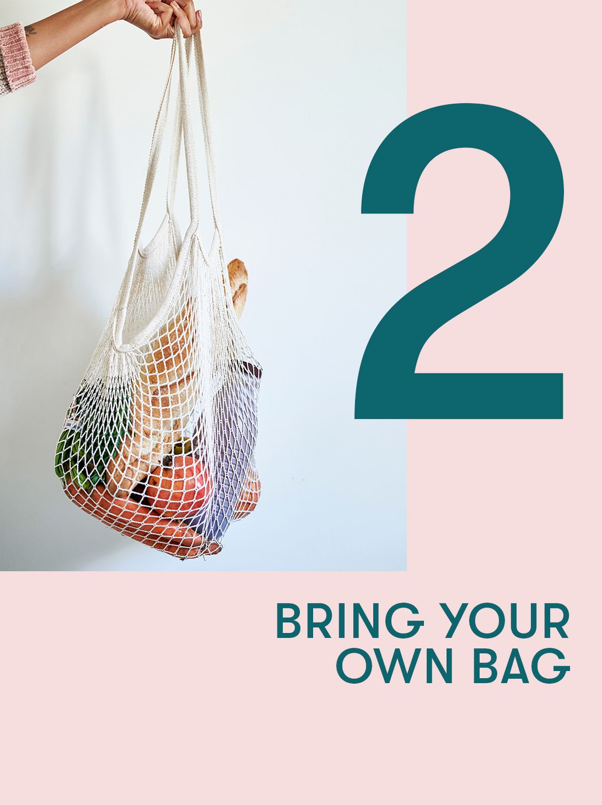 A person holds a mesh tote bag filled with groceries in front of a white backdrop
