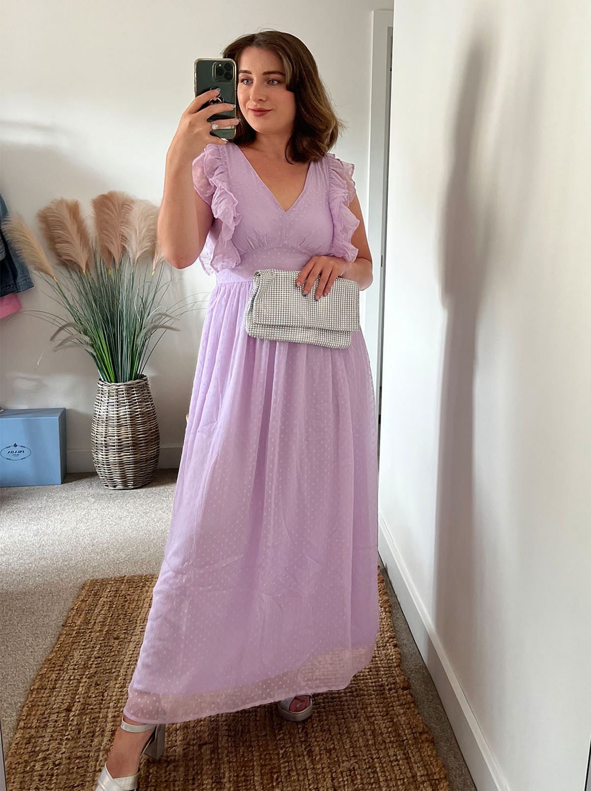New Look's Charlotte stands in a room in front of a mirror wearing a light pink maxi dress from VILA