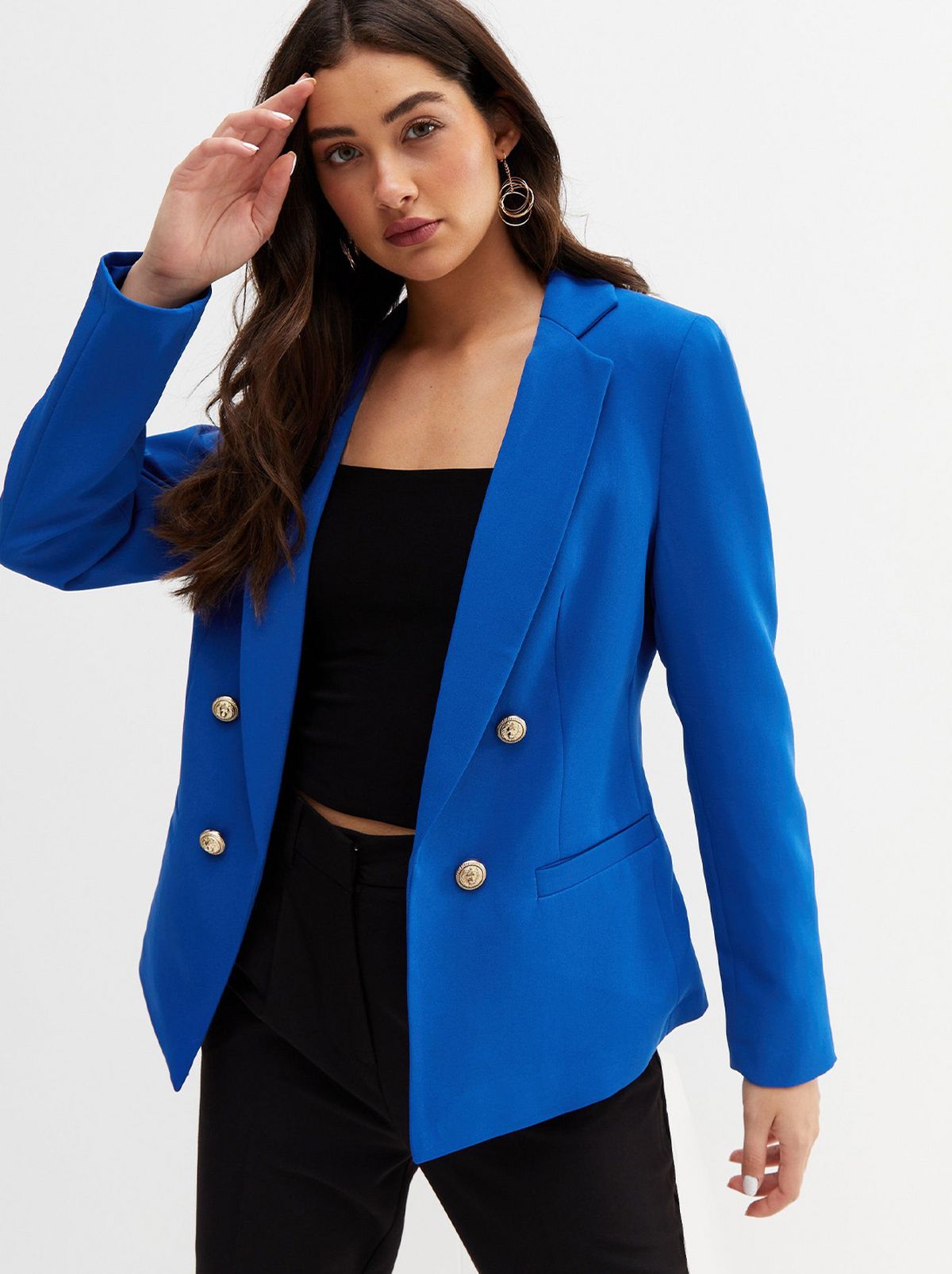 Woman wearing a blue blazer, black top and black jeans
